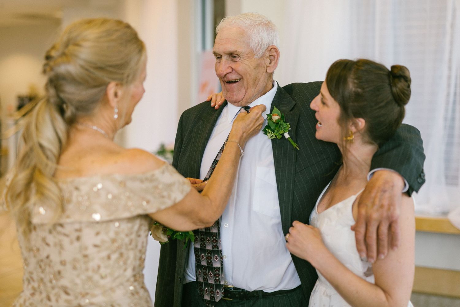 Wedding guests share an emotional moment during reception celebrations.