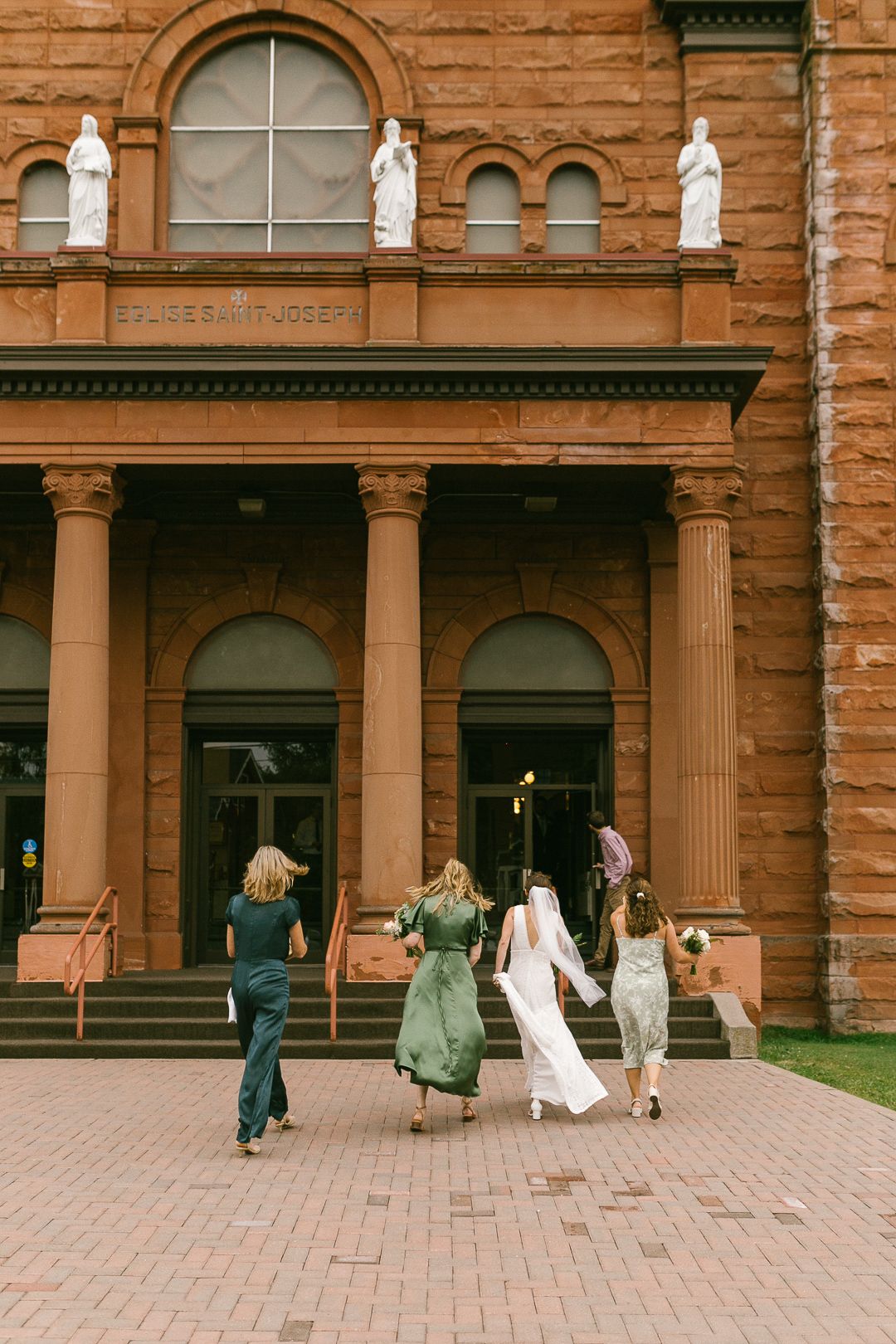 A historic brownstone building with arched windows and classical columns.