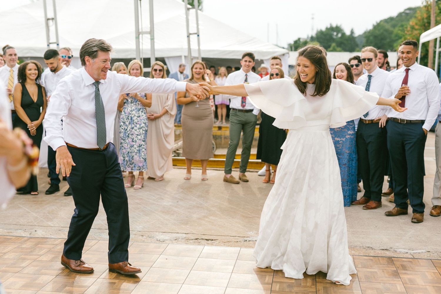 Wedding reception dance floor with guests celebrating and dancing in a festive atmosphere.