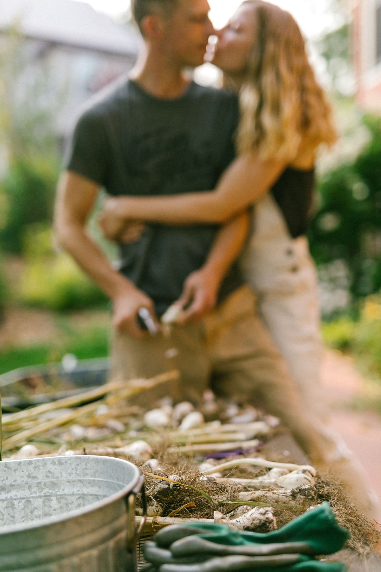 Close-up of couple sharing intimate moment while grilling outdoors.