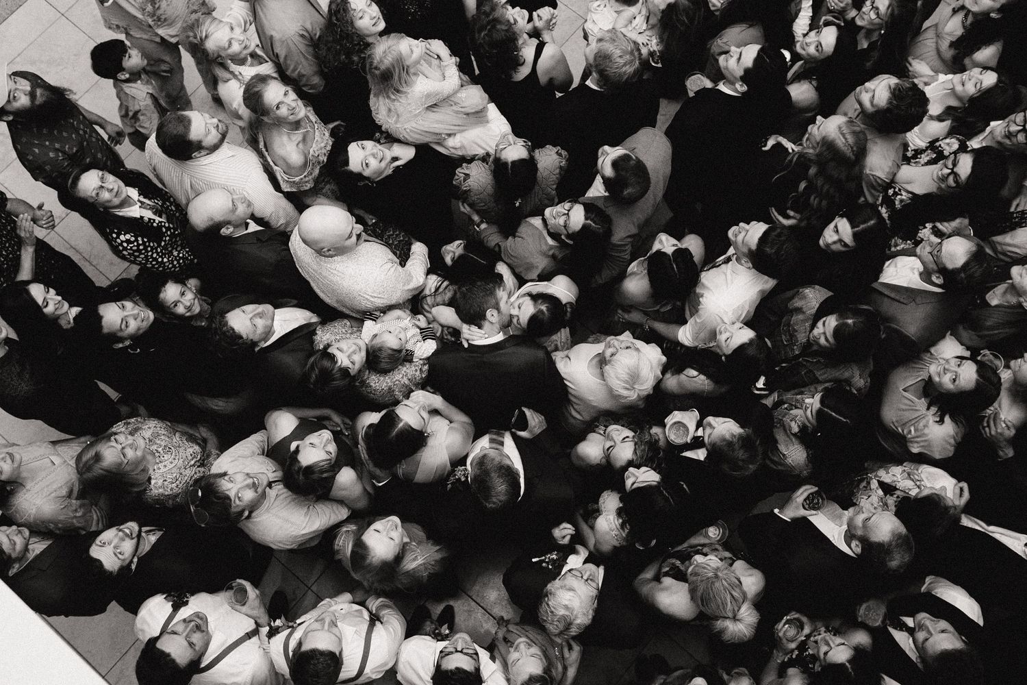 Aerial black and white photo showing a densely packed crowd of people viewed from above.