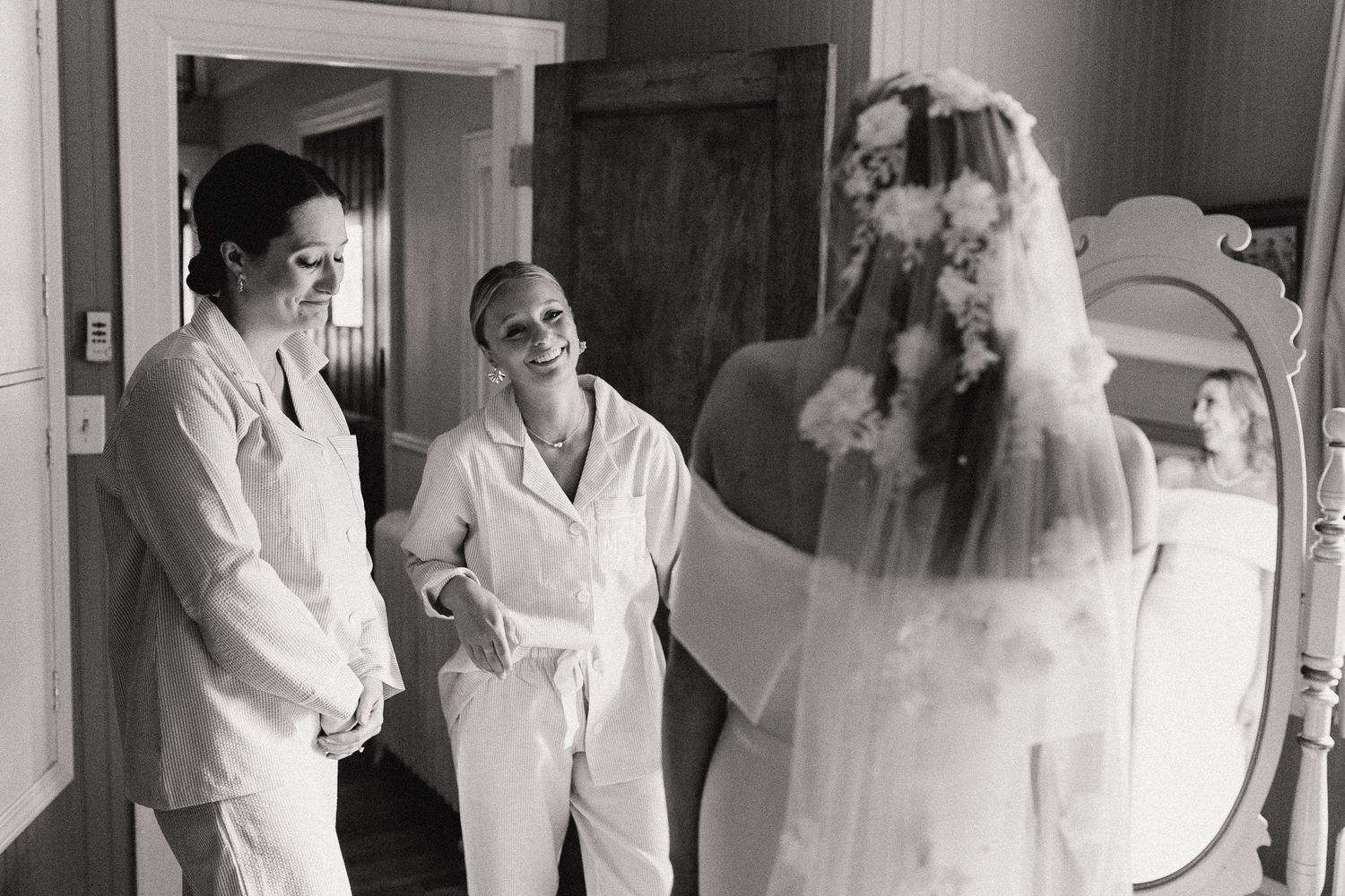 A candid black and white photo showing wedding day preparations.