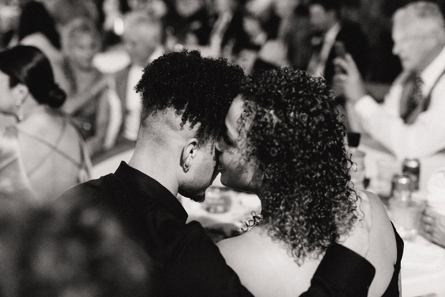 A tender moment shared between wedding guests during a wedding reception celebration.