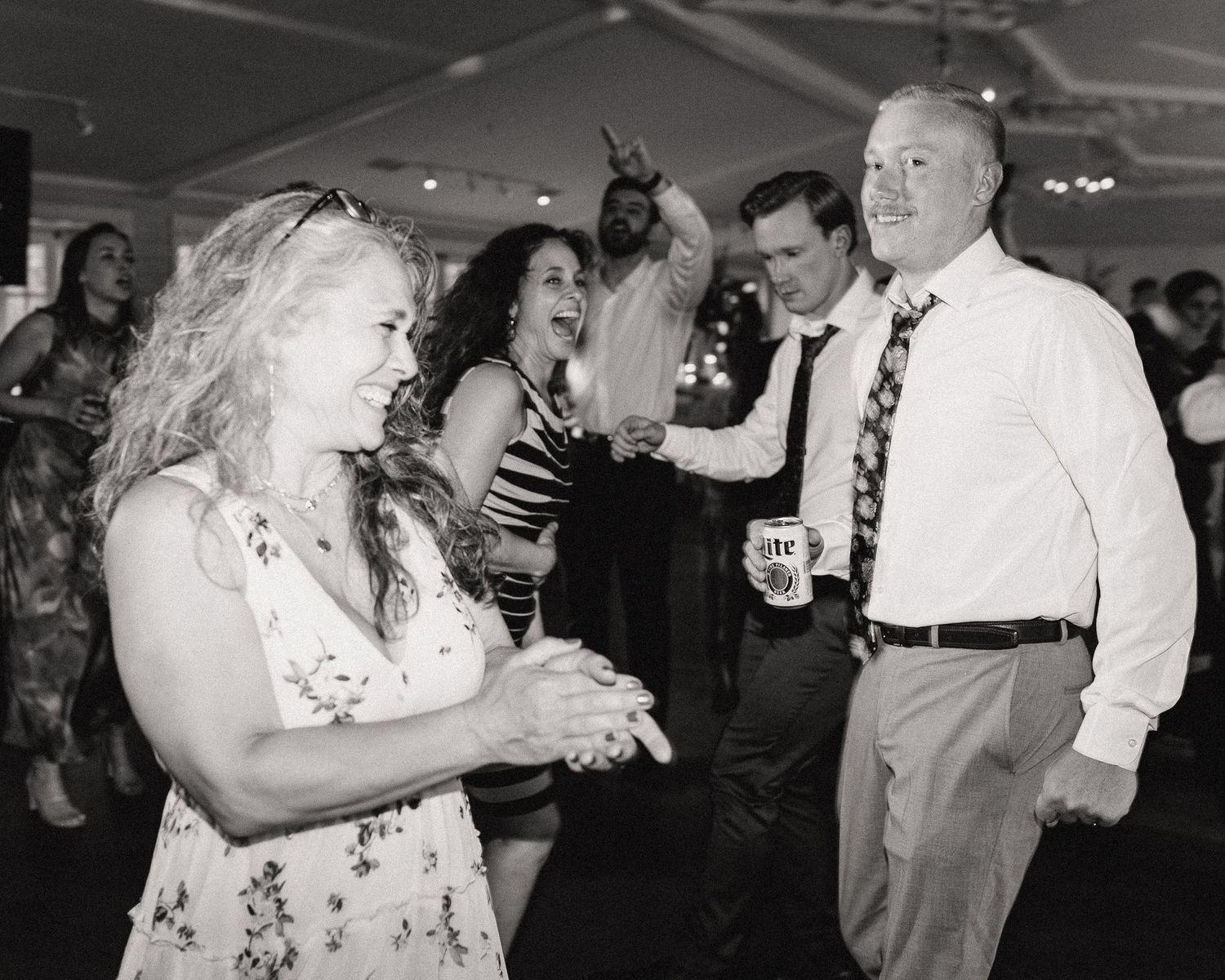People dancing together at a formal event in black and white photography.