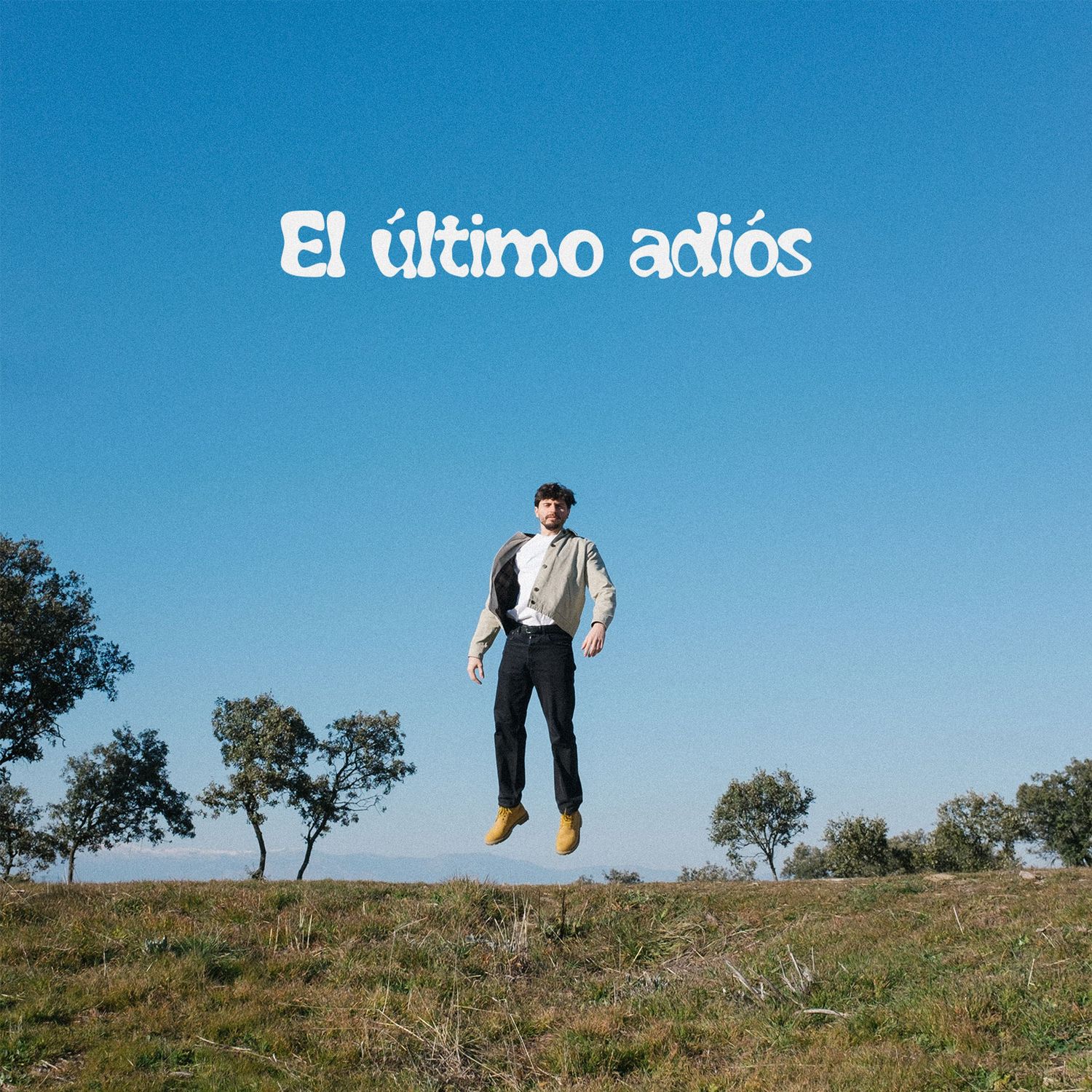 Man jumping in the air outdoors with text El ultimo adios against a bright blue sky.