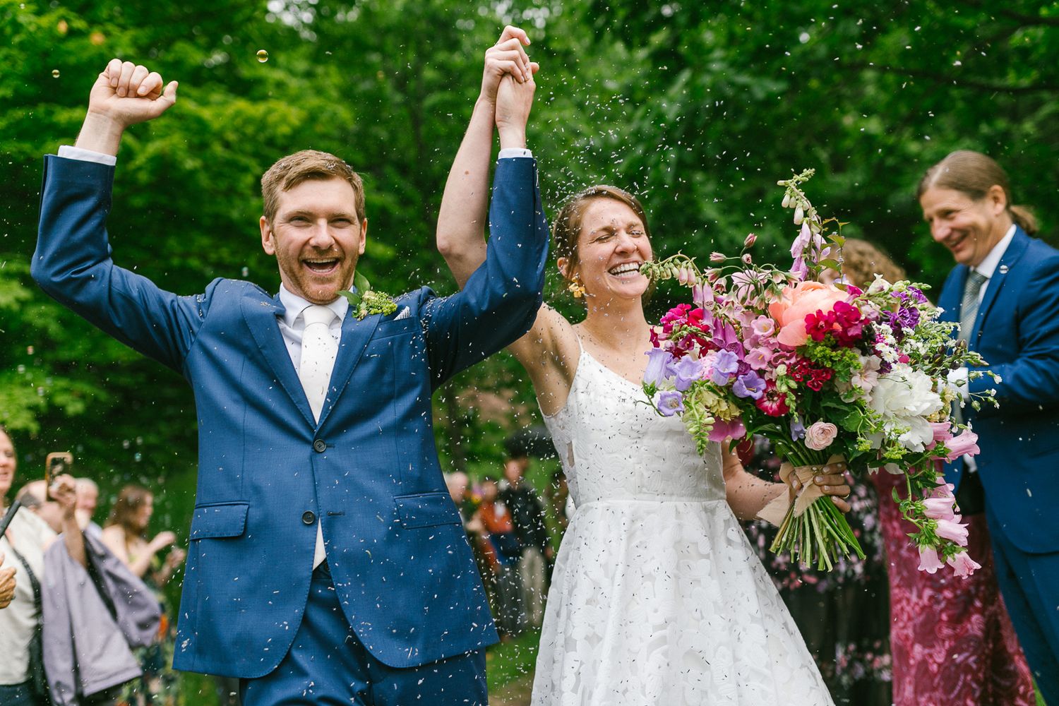 A joyful wedding celebration with colorful floral arrangements in an outdoor garden setting.