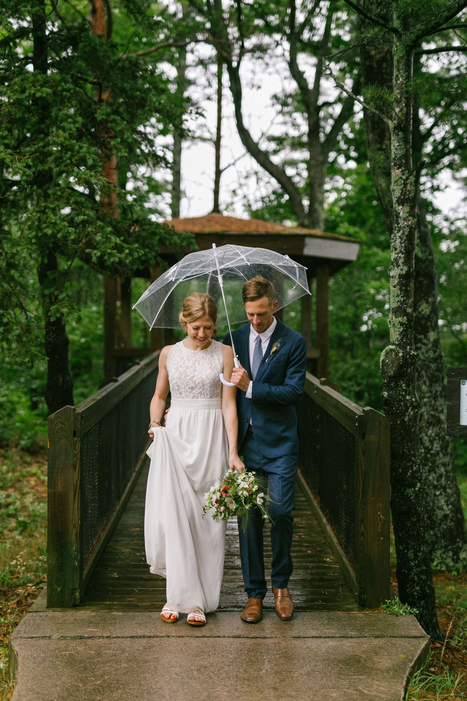 Bride and groom at their rainy beach wedding in Michigan