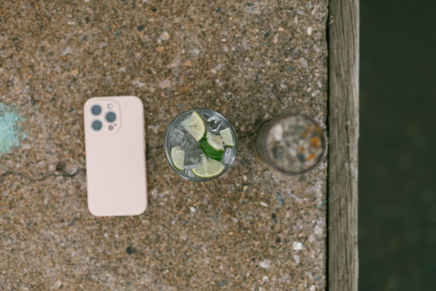 Close-up of seashells and natural objects arranged on a weathered wooden surface.