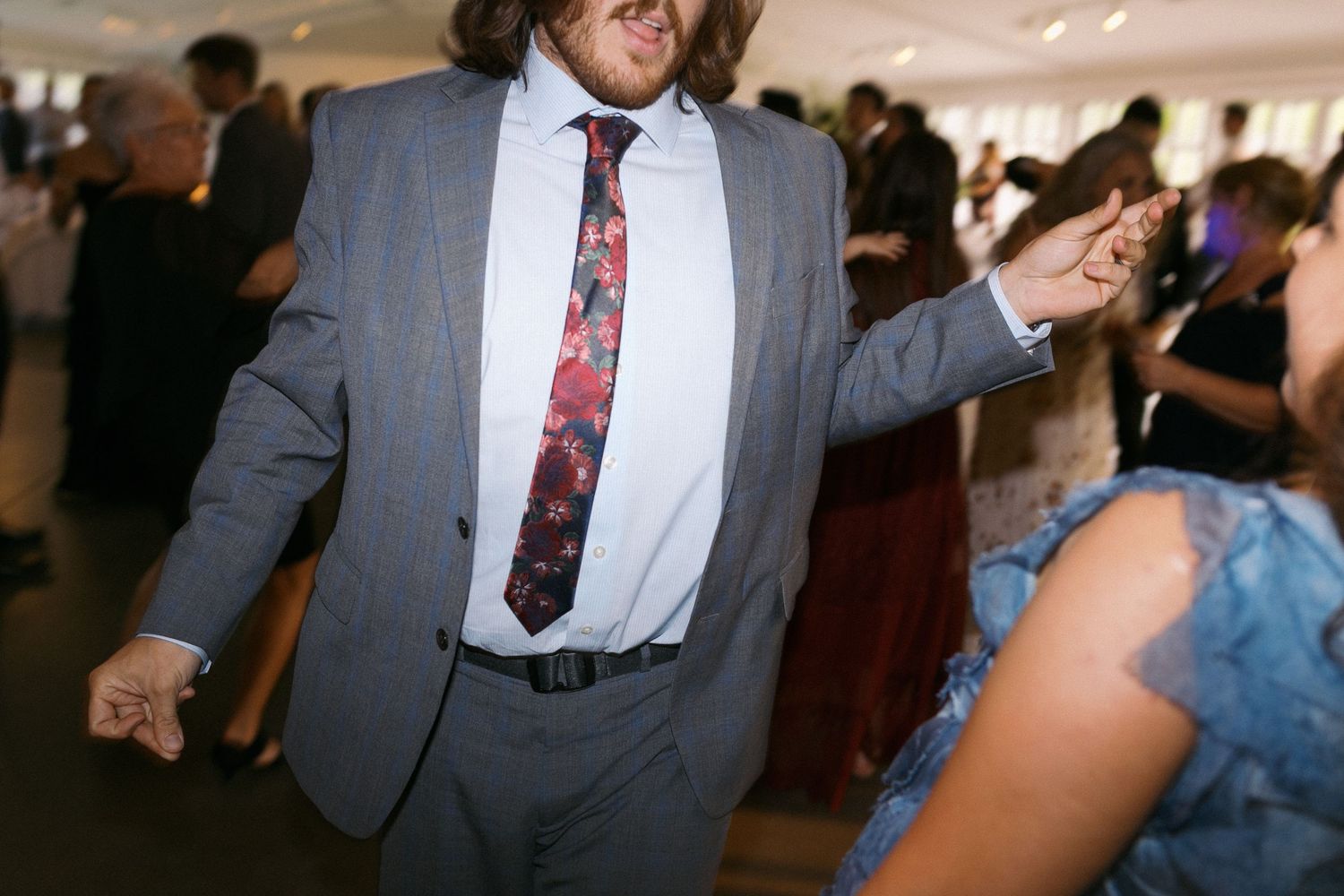 Candid moments of wedding guests dancing and laughing at an indoor reception.