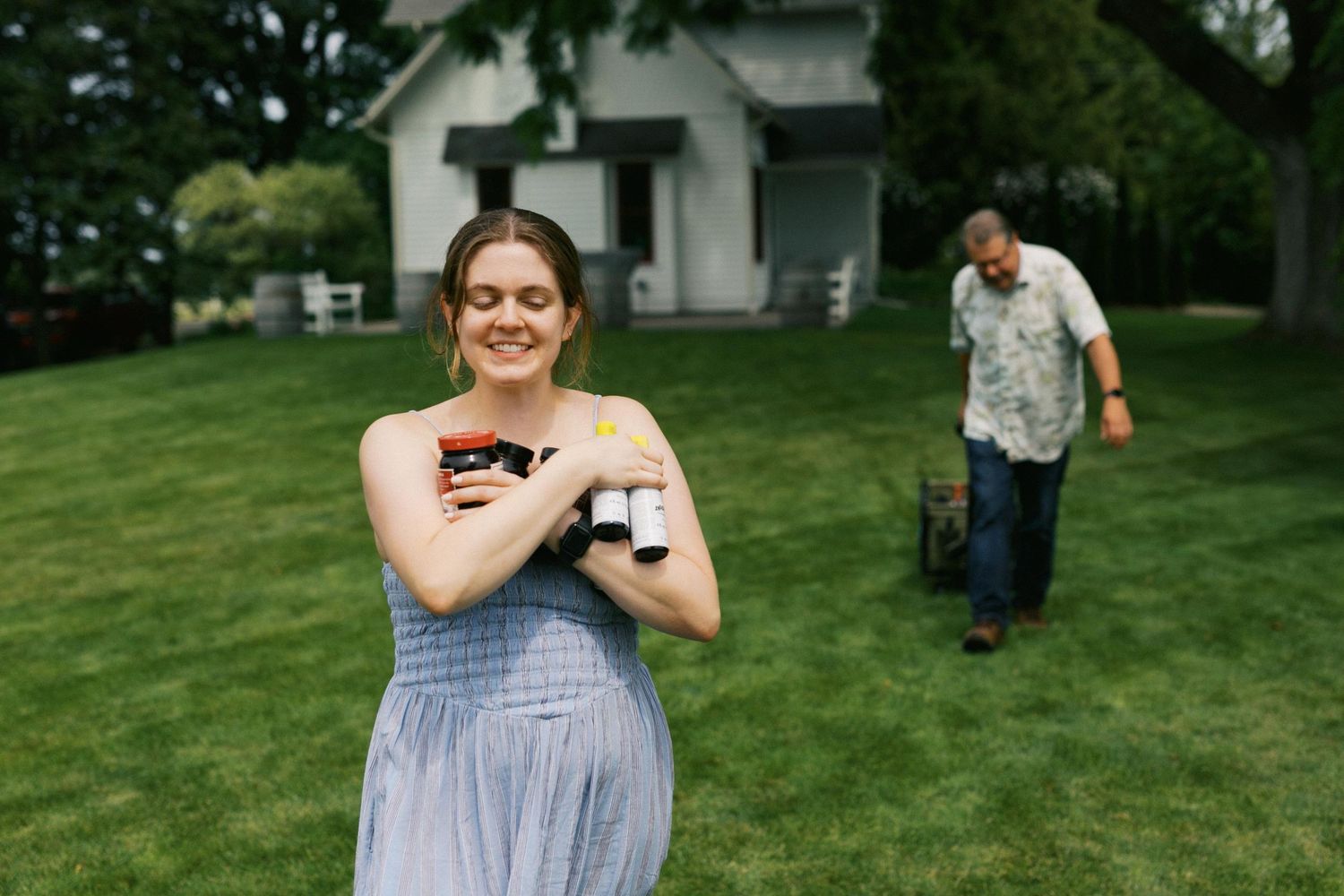 A series of candid outdoor photos showing a couple celebrating a special moment in a grassy backyard setting.