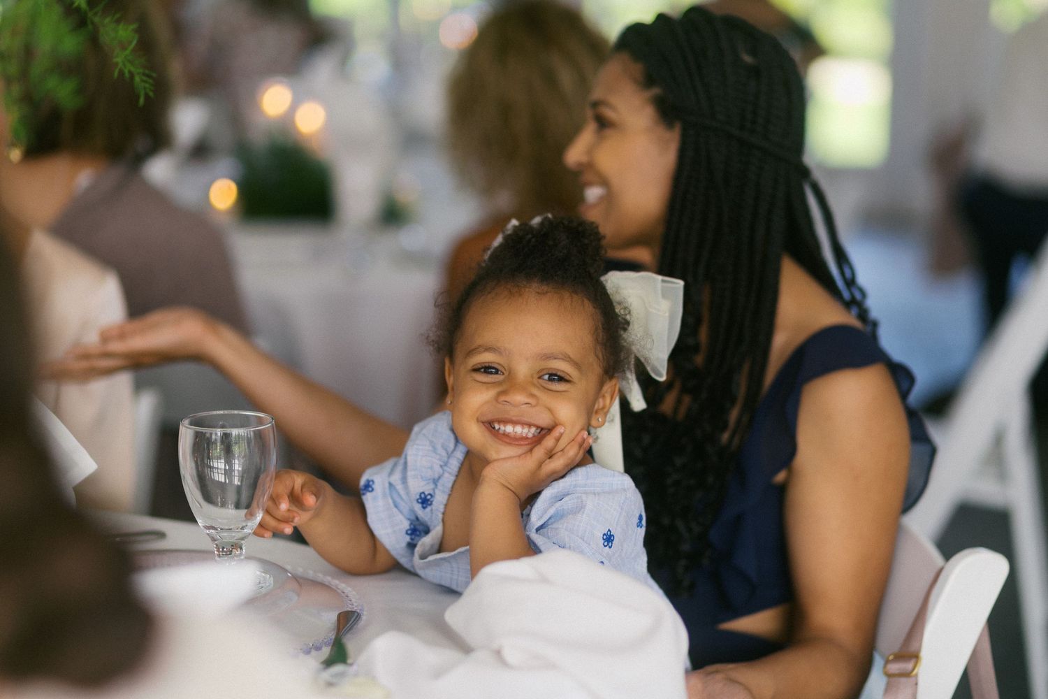 Candid moments from a wedding reception showing guests enjoying themselves at tables.