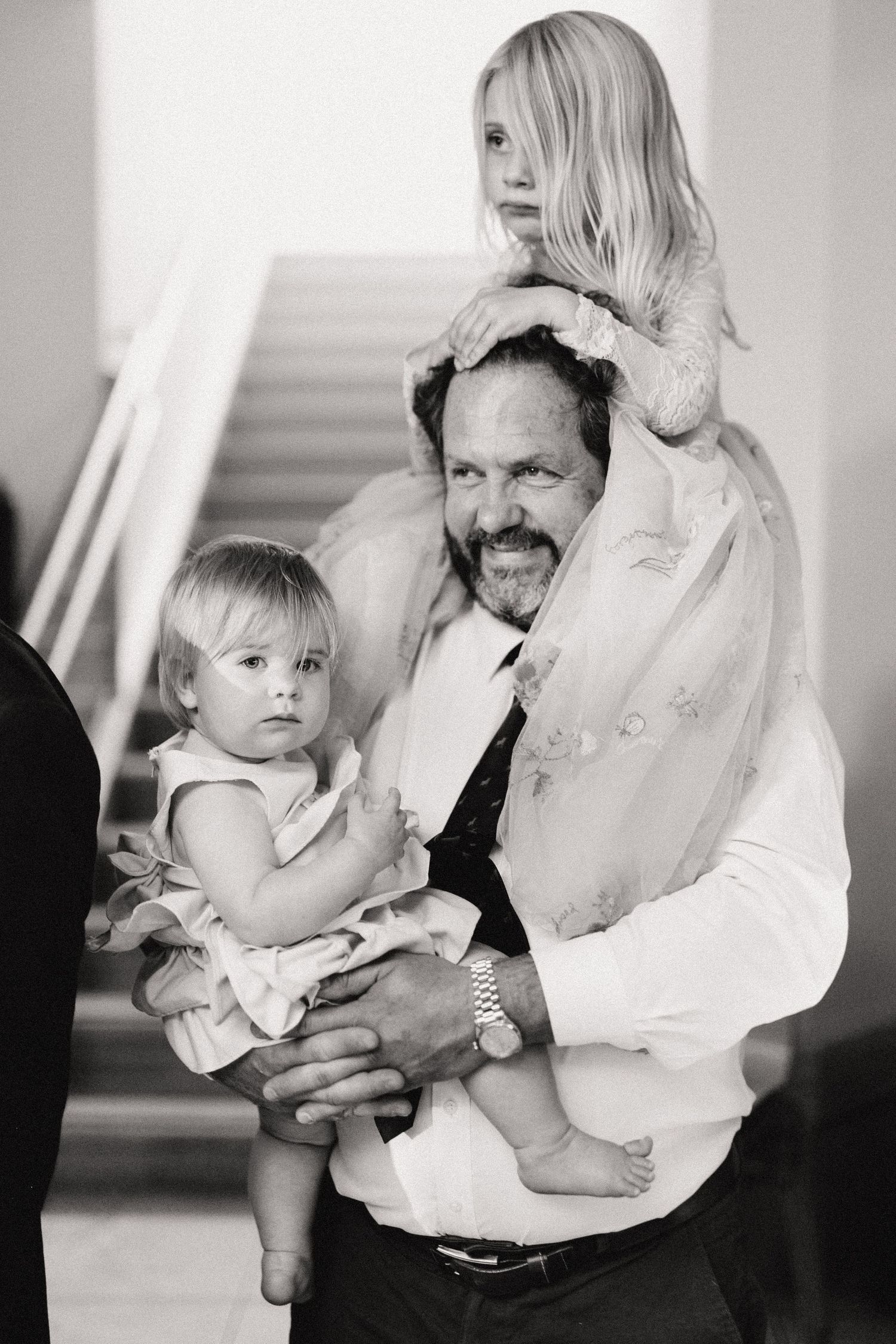 Black and white portrait of loved ones posing together, showing joy and connection in an intimate family moment.