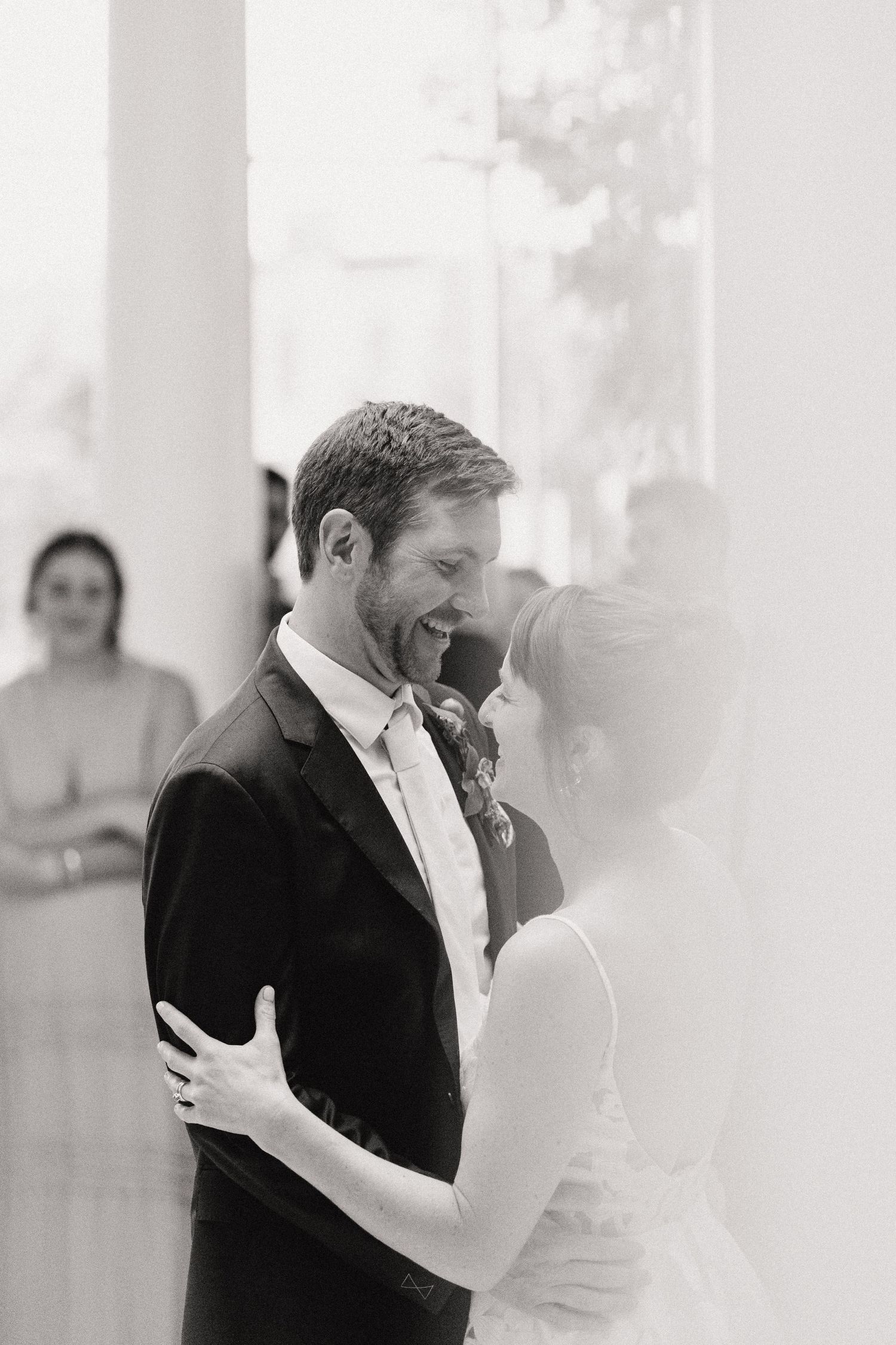 A tender black and white moment between newlyweds sharing their first dance.