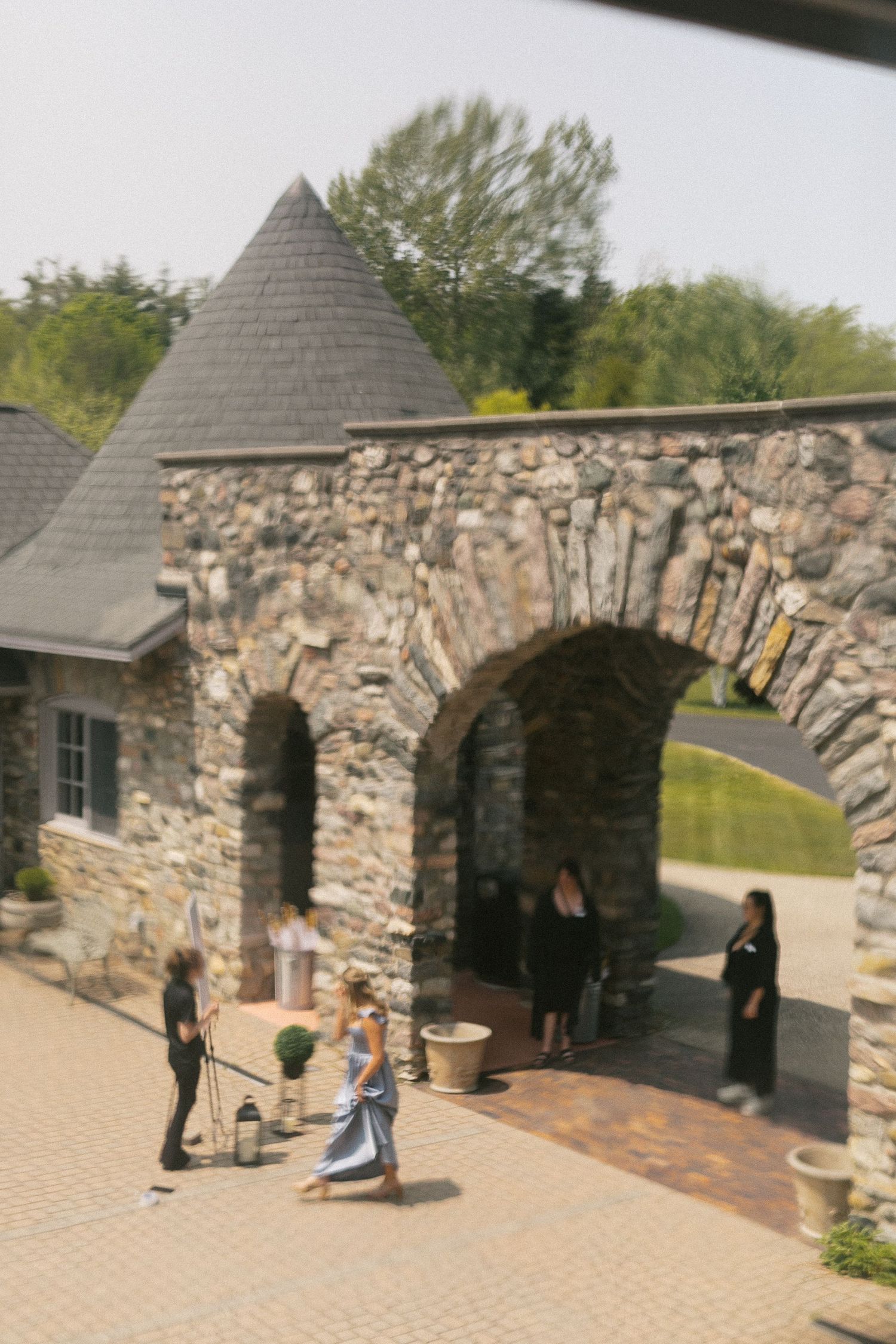 A sequence of playful moments captured outside a stone castle-like structure.
