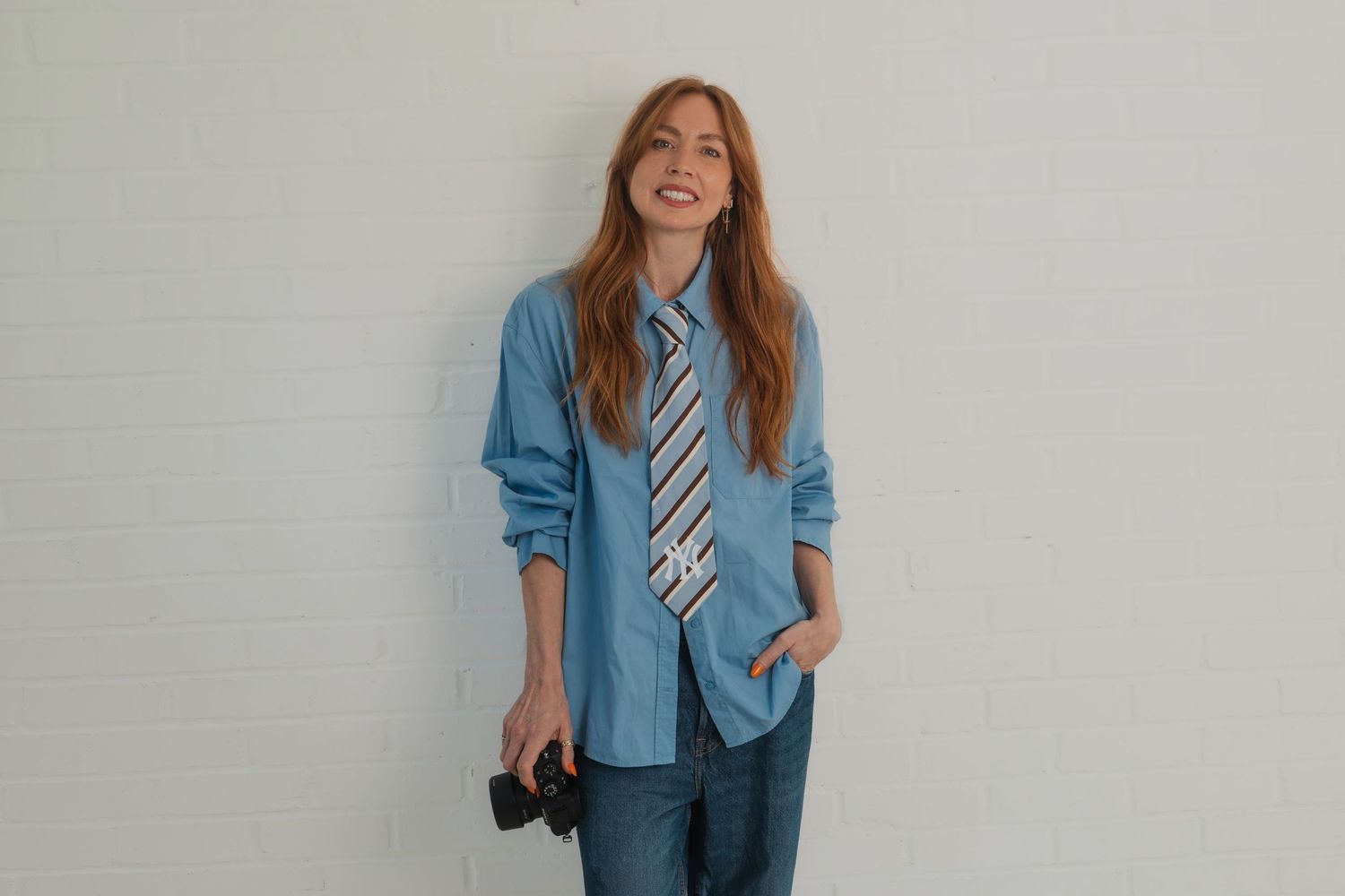 Jenny Gall holding camera in studio in Rochford, Essex.