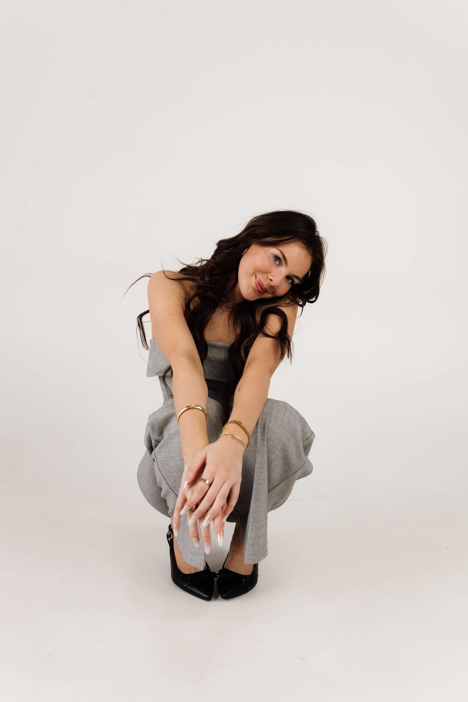 Model poses in casual grey outfit against white background showing different seated positions.