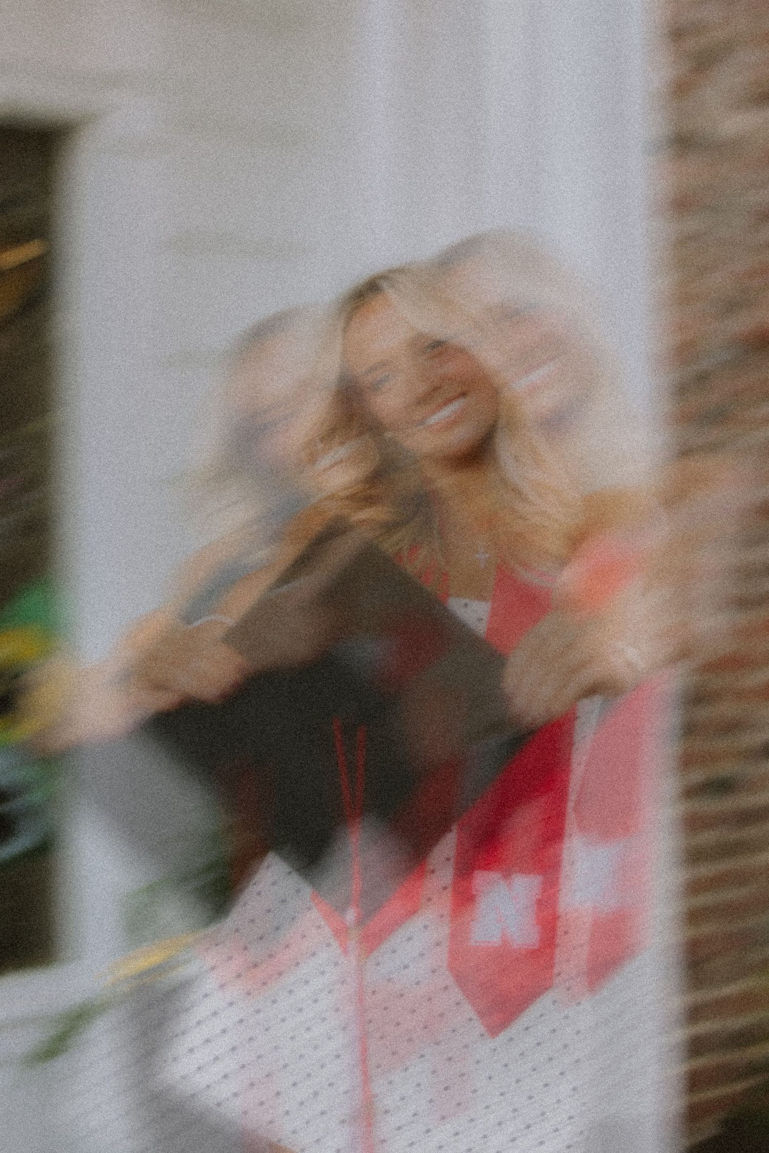 Artistic blurred motion portrait showing joyful graduation celebration.