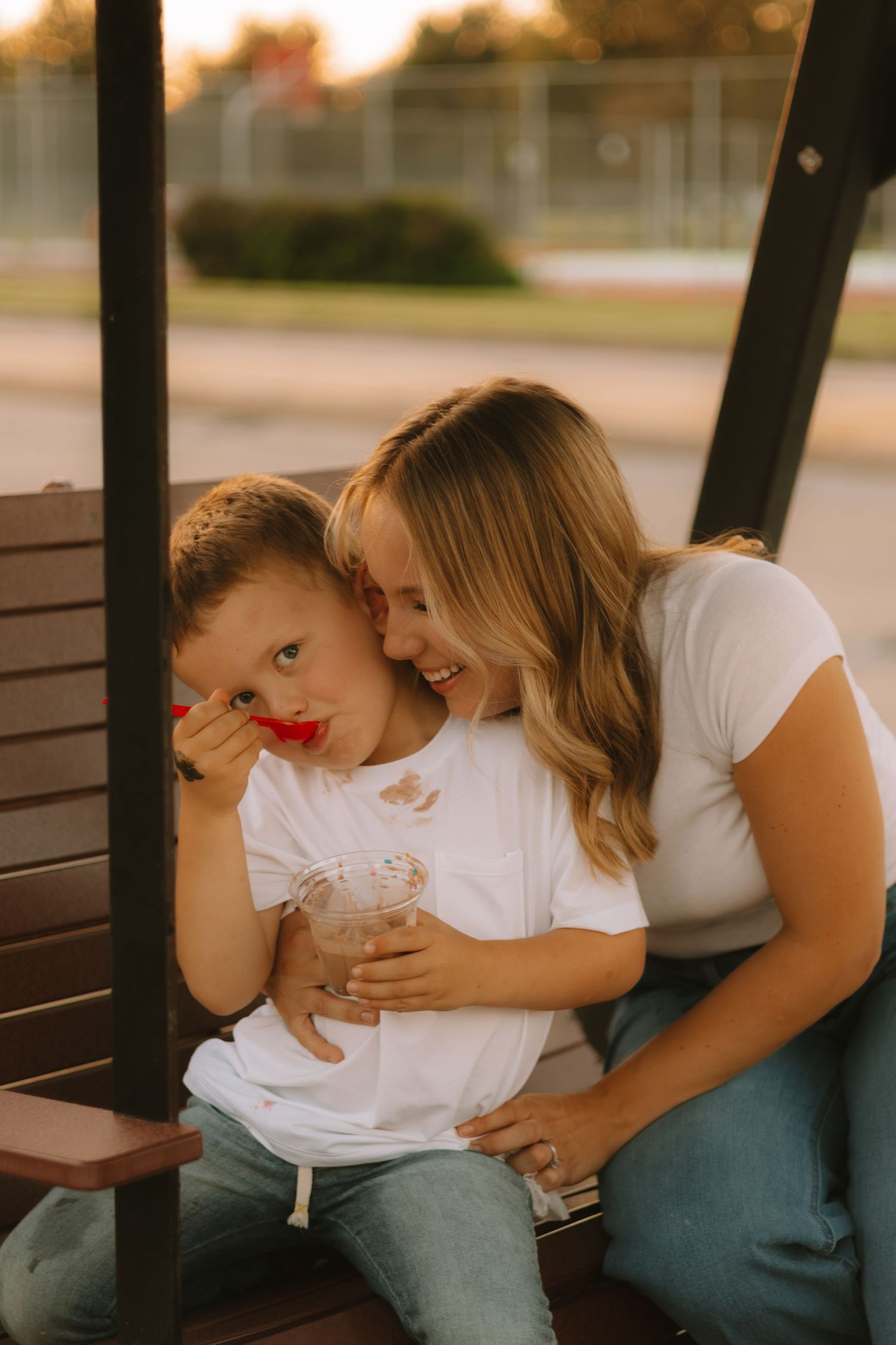 A tender moment shared between parent and child on a wooden bench.