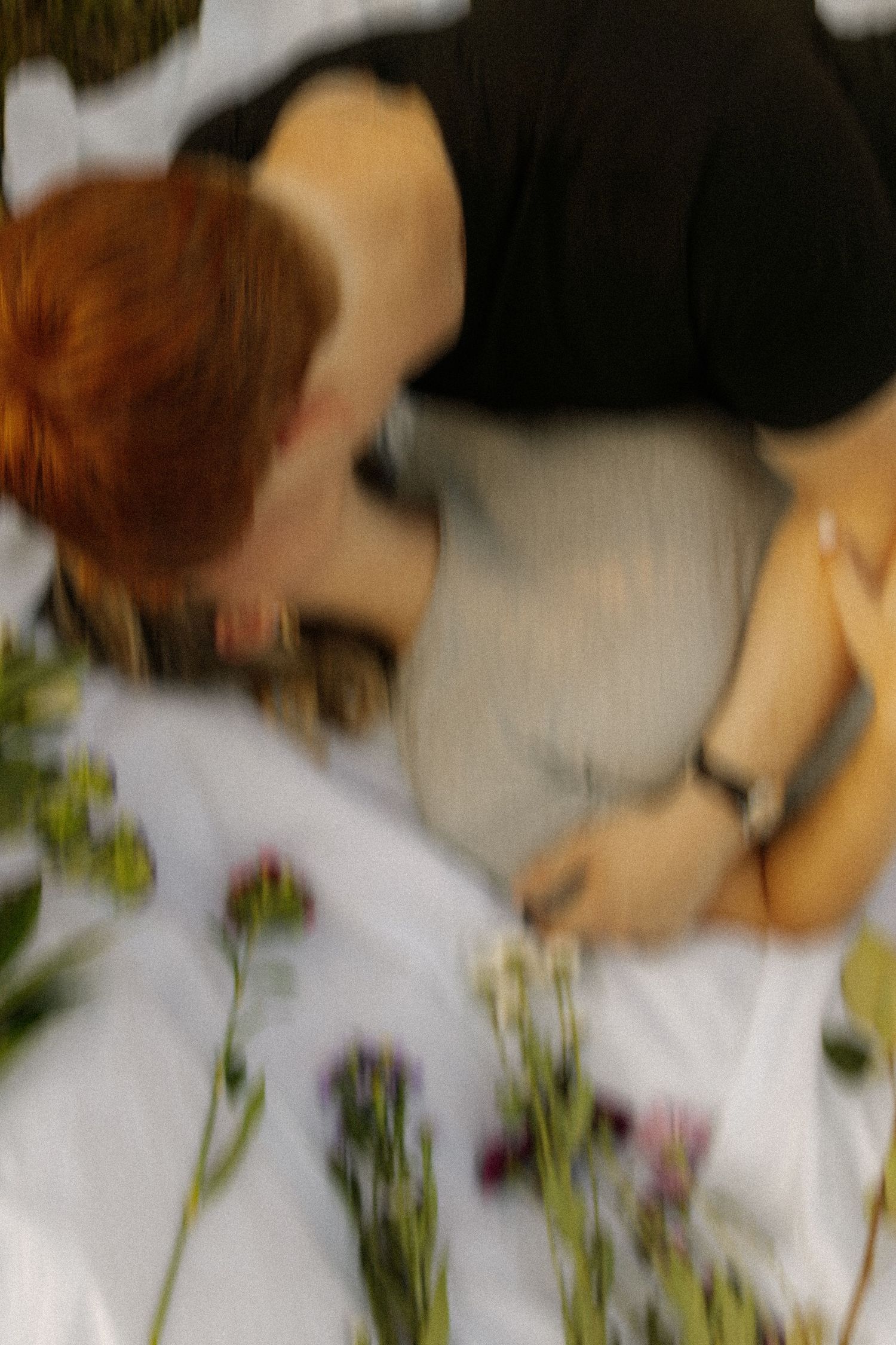Blurred close-up photo showing flowers and soft focus details in muted tones.