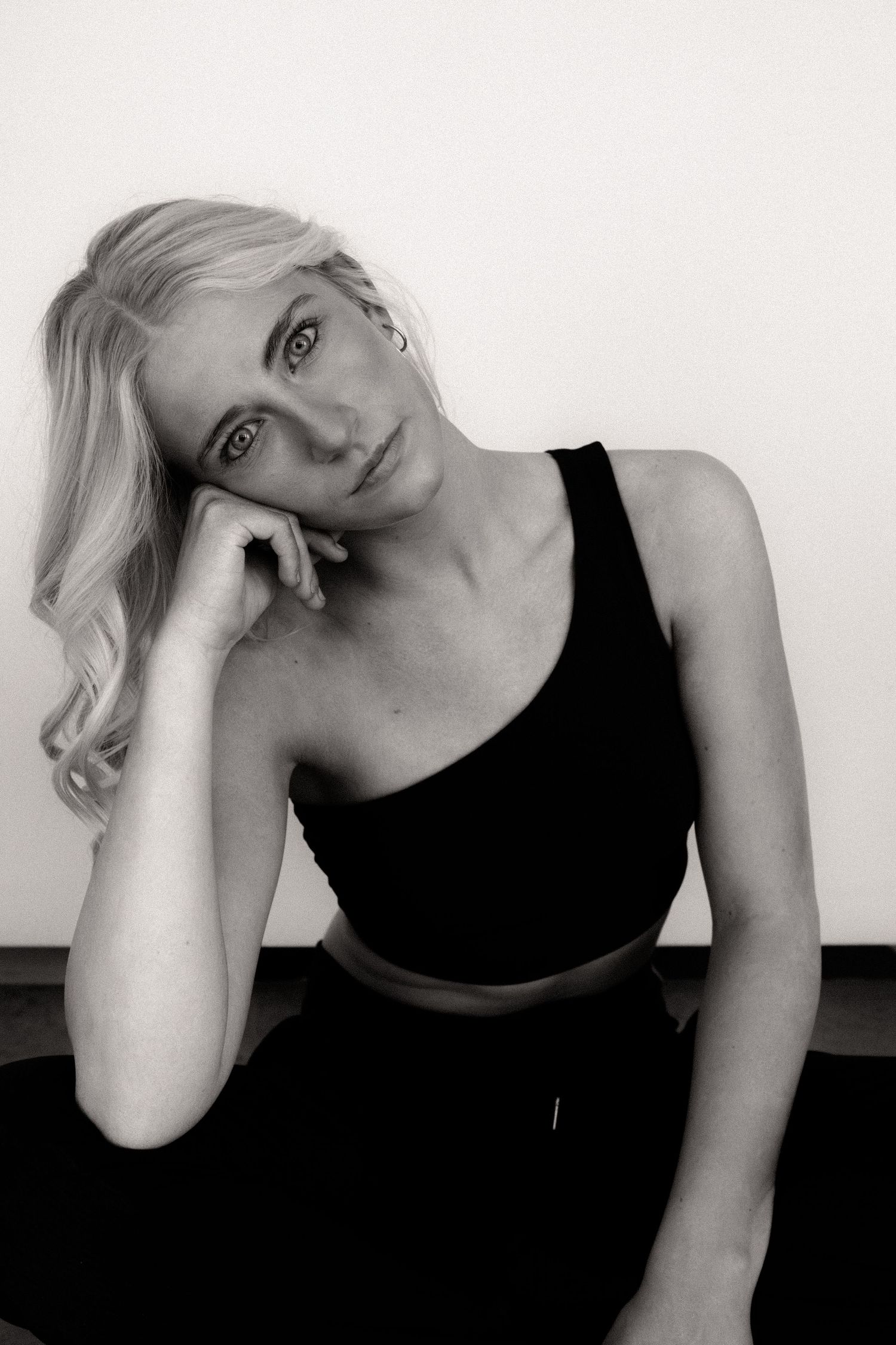 Artistic portrait series in black and white showing contemplative poses against white background.