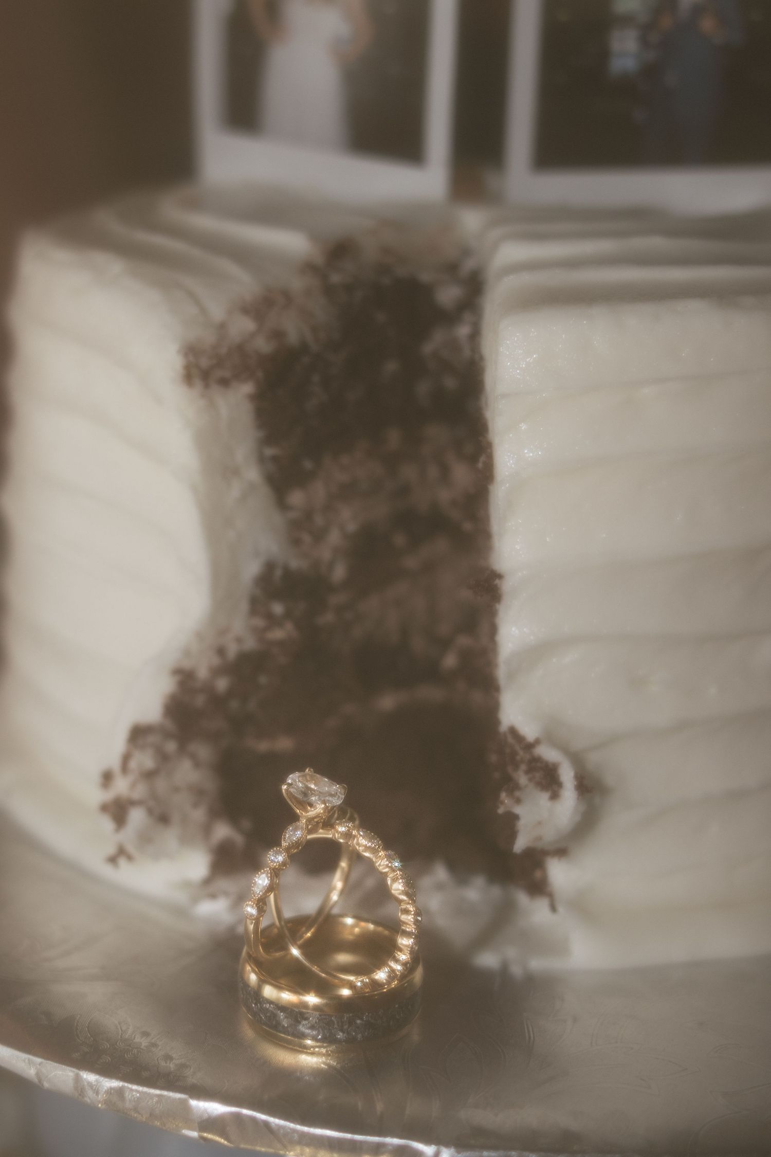 Wedding rings photographed in sepia tones with artistic blur effect.