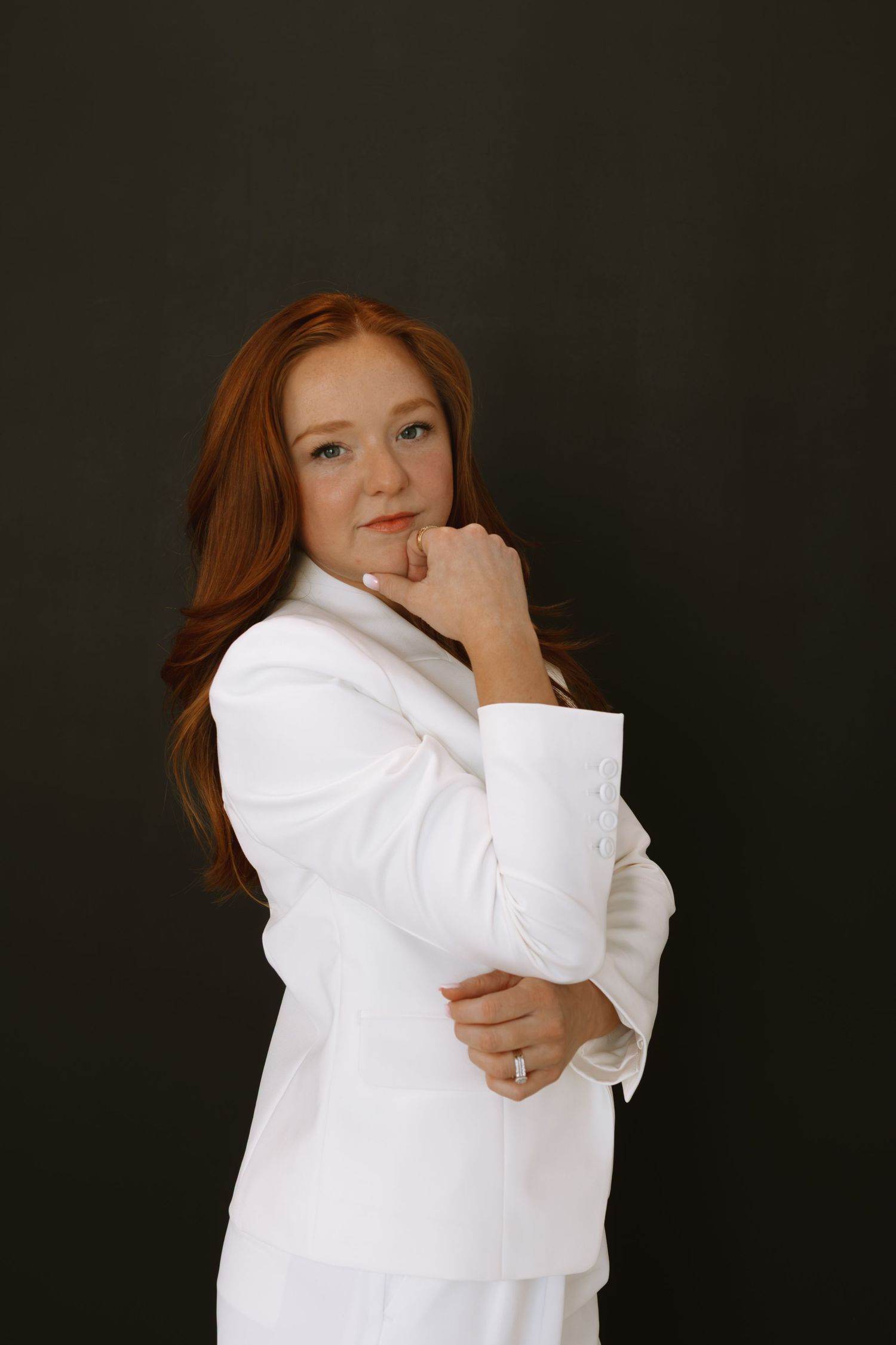 Portrait series of person in white shirt against dark background showing playful expressions.