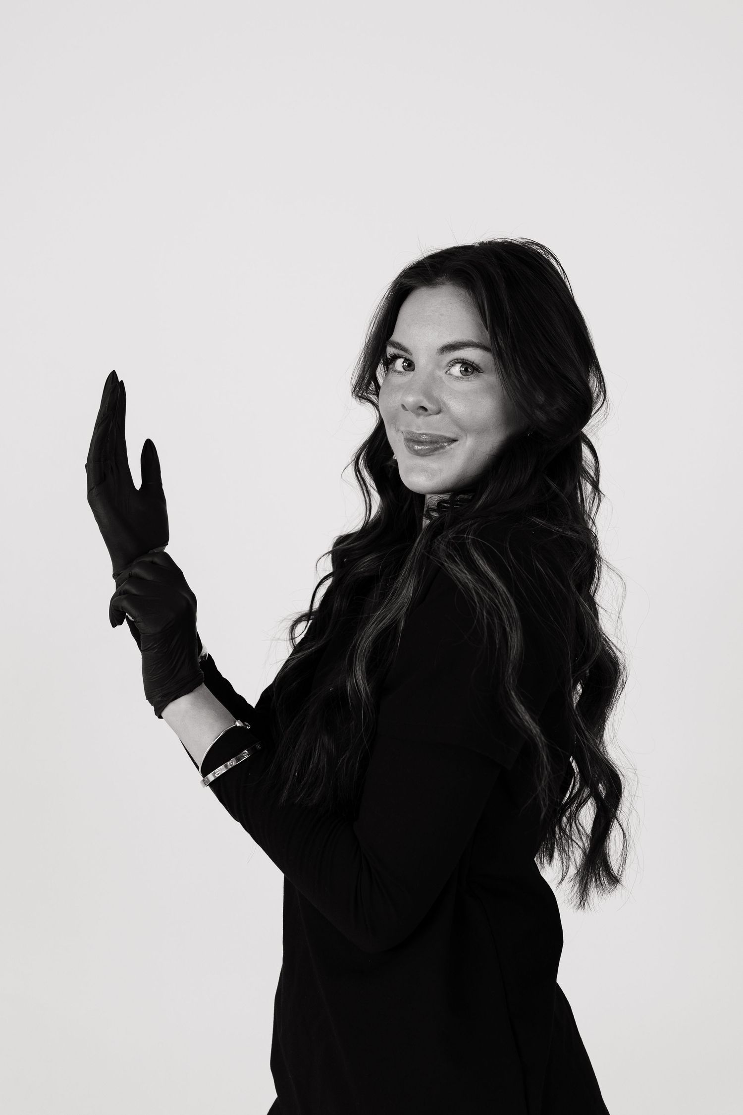 Artistic black and white portrait series showing expressive poses in dark clothing.