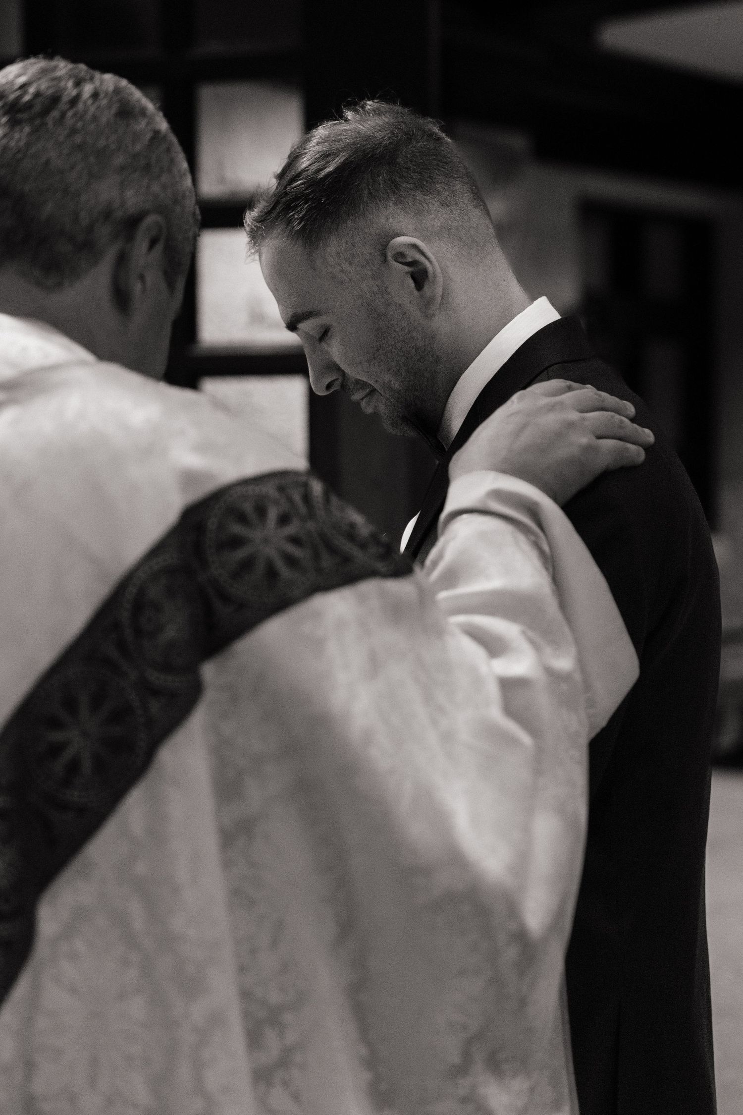 Intimate black and white portrait of a tender wedding moment.