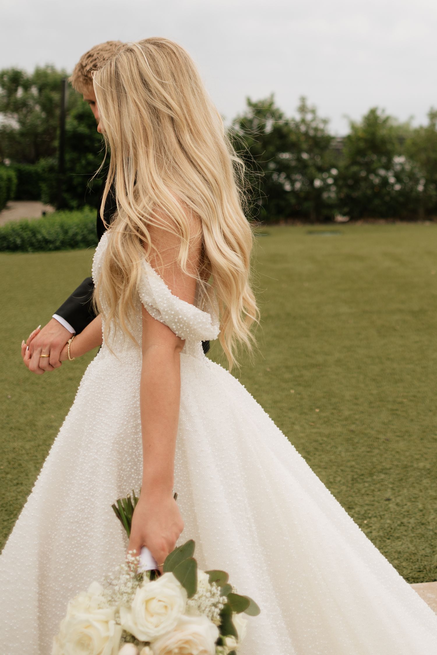 Series showing movement of a white wedding dress flowing in an outdoor setting.