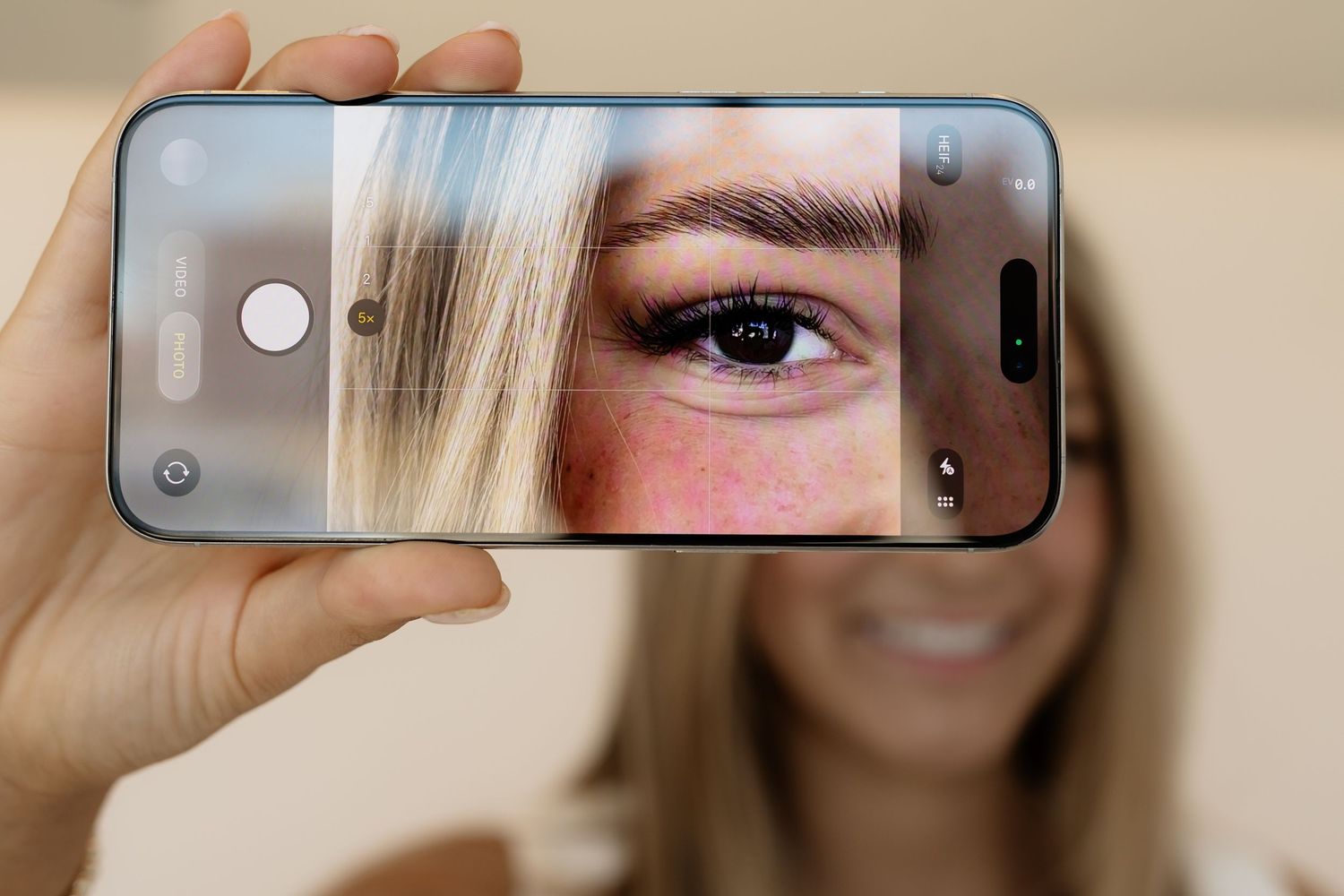 Close-up view of eyes and phone camera reflections showing multiple perspectives of a person's gaze.