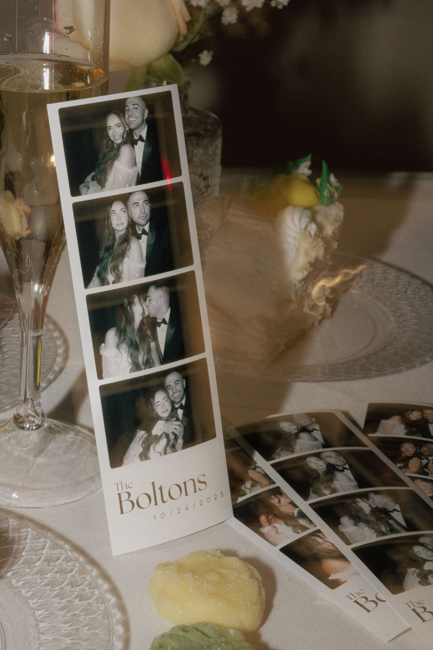 Wedding reception table with photo frames, champagne glasses, and decorative elements.