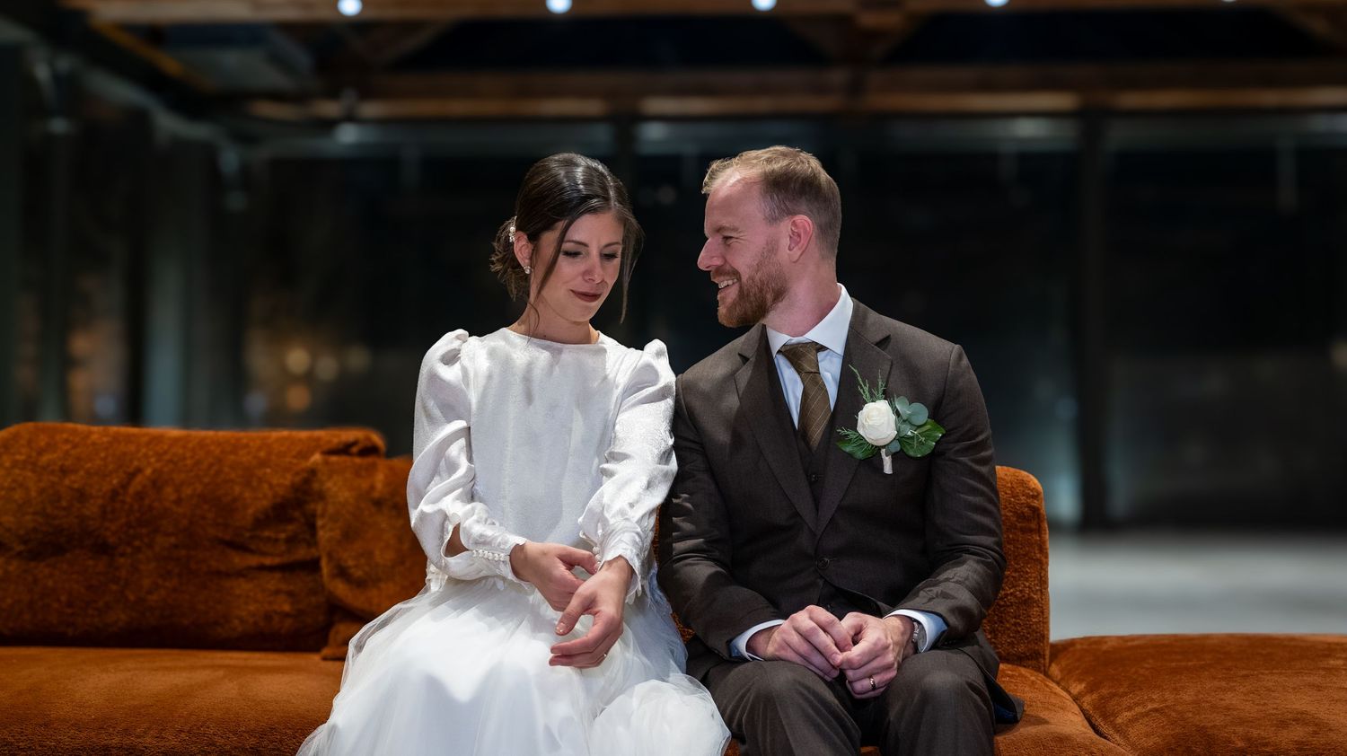 Candid wedding moments captured in a rustic venue with wooden interior details.
