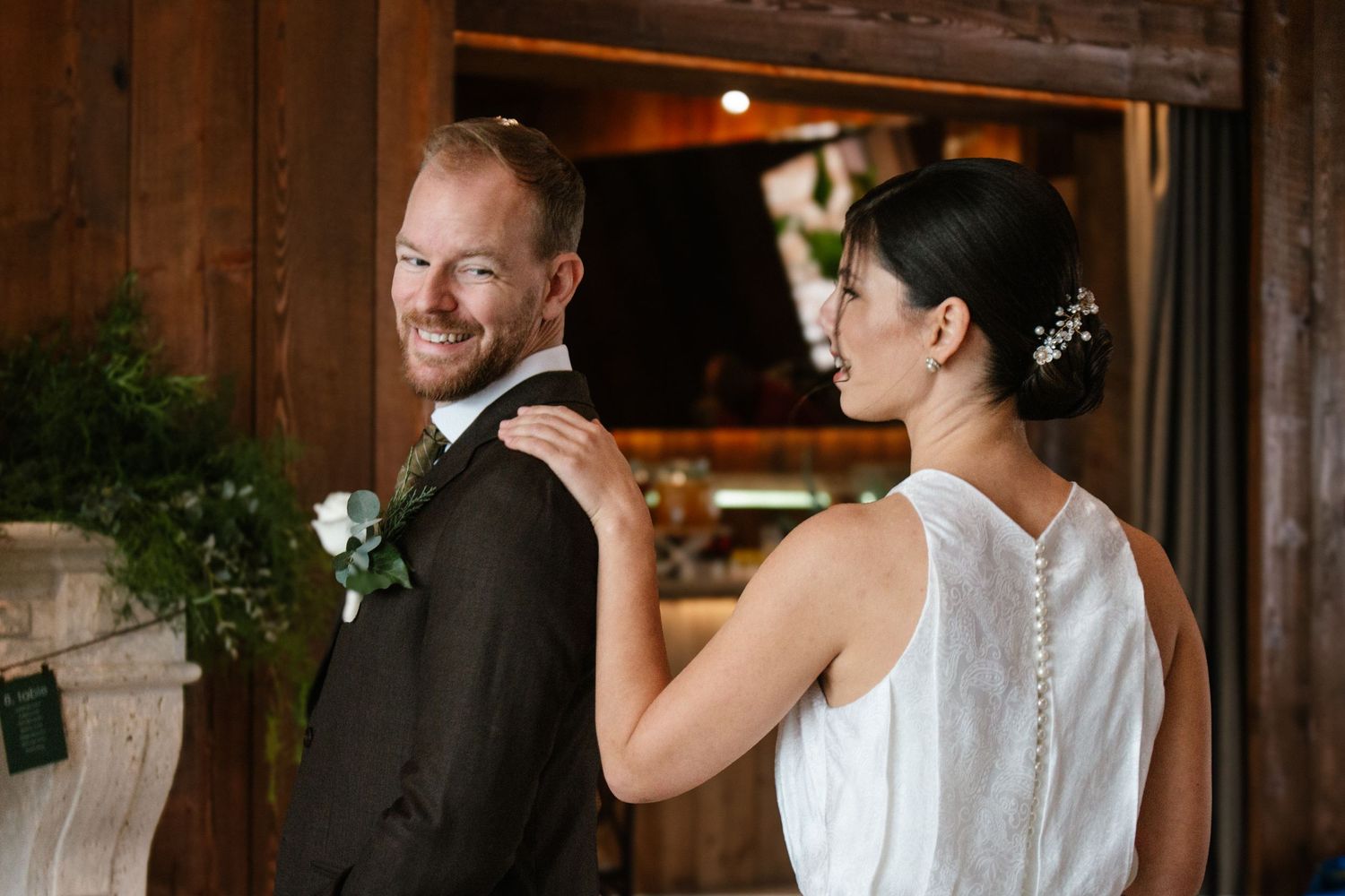 A tender moment captured during a wedding first dance in a warmly lit reception venue.