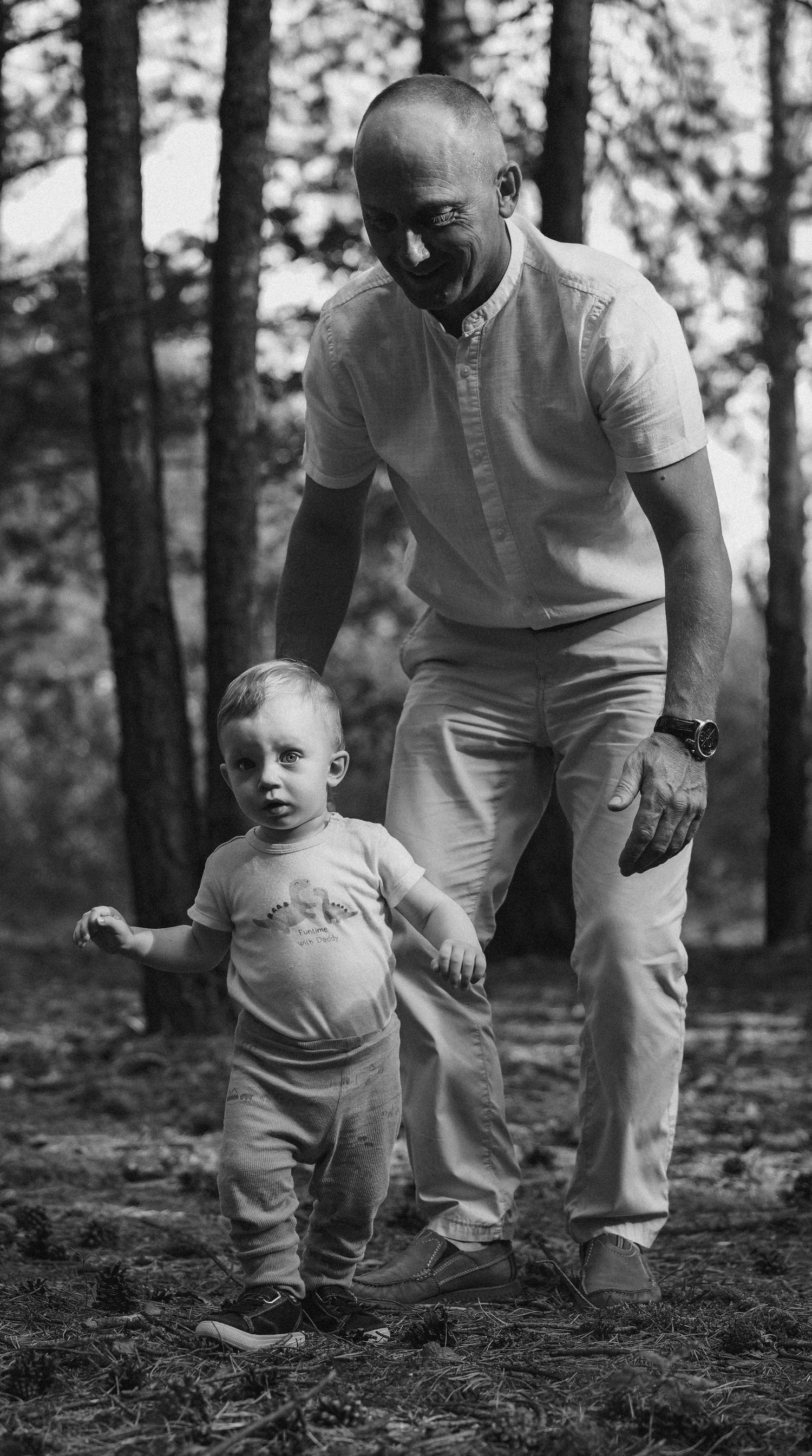 Black and white photos showing adults and a small child walking together in a wooded area.