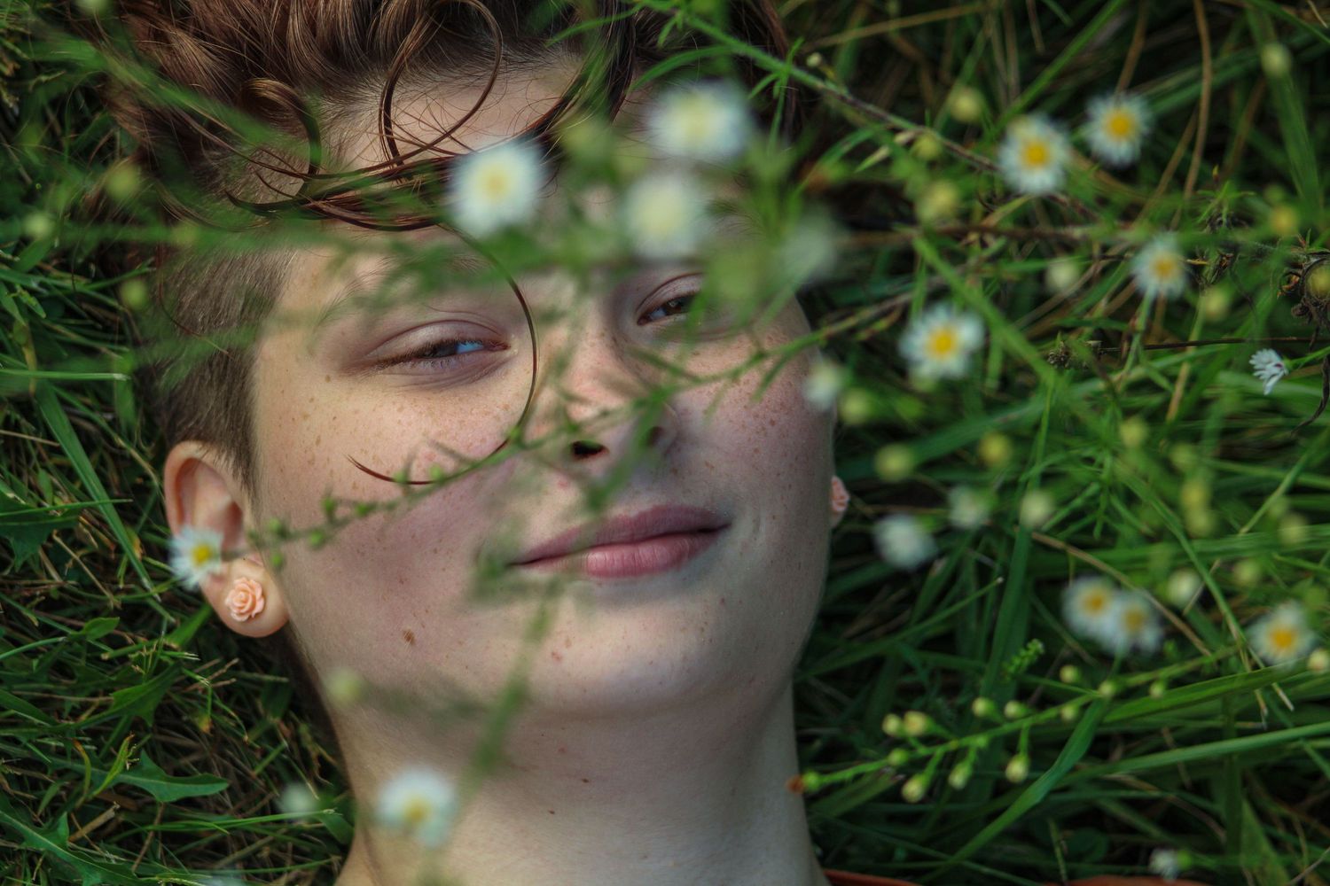 Yellow wildflowers and green grass create a natural outdoor setting.