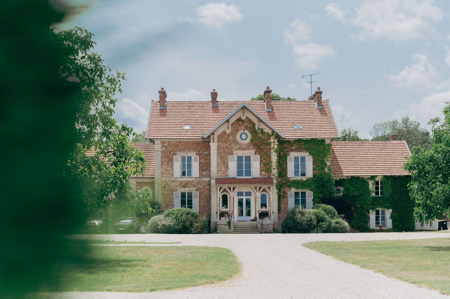 A charming ivy-covered French country estate serves as a picturesque wedding venue.