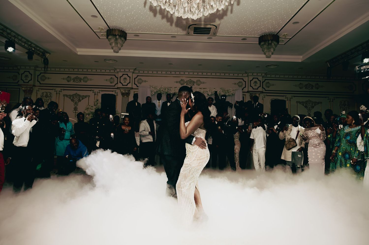 Couple embraces during romantic first dance enveloped in billowing fog.