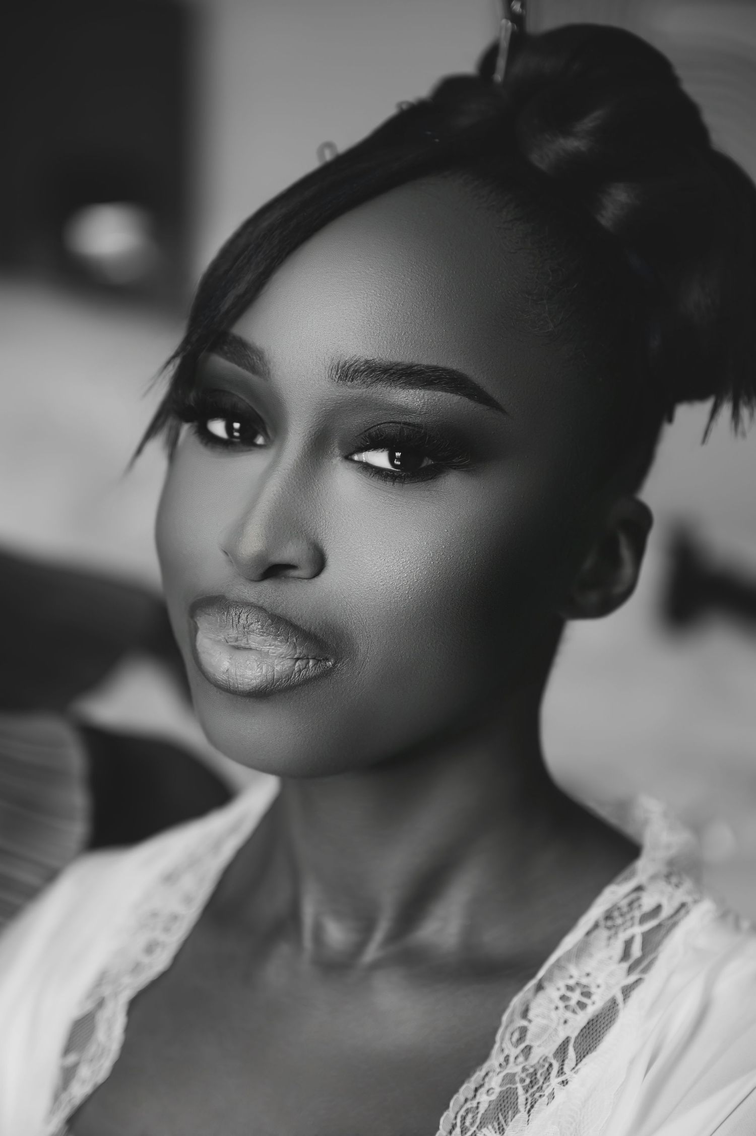Black and white bridal portrait of bride with elegant updo and dramatic eye makeup.