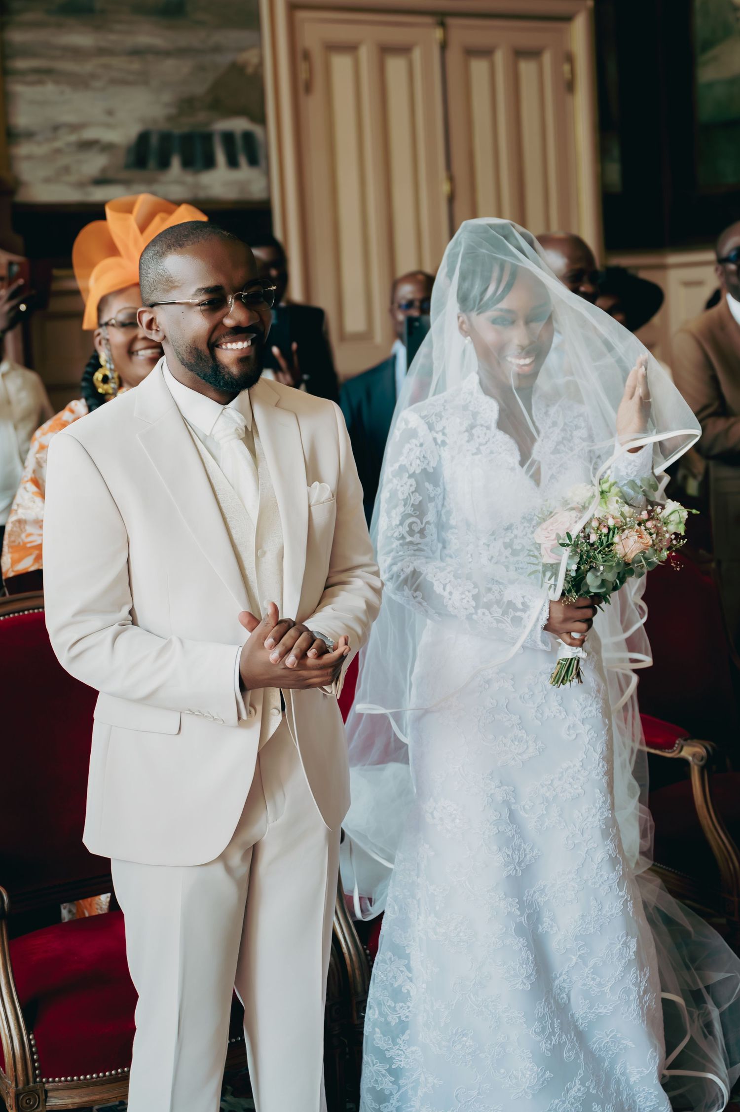 Joyful bride and groom walk down aisle together after wedding ceremony.