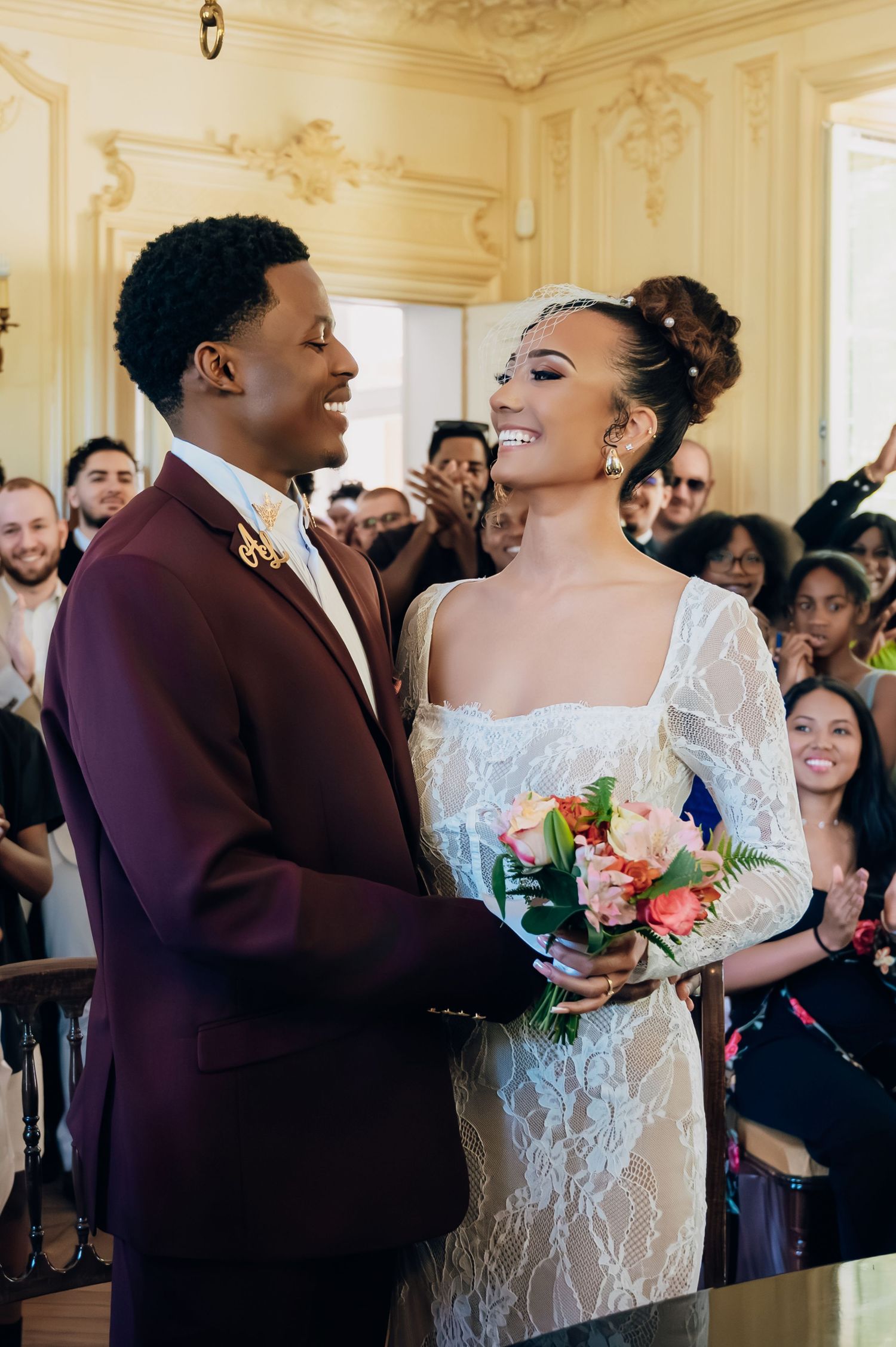 Joyful bride and groom sharing a moment at altar during wedding ceremony.