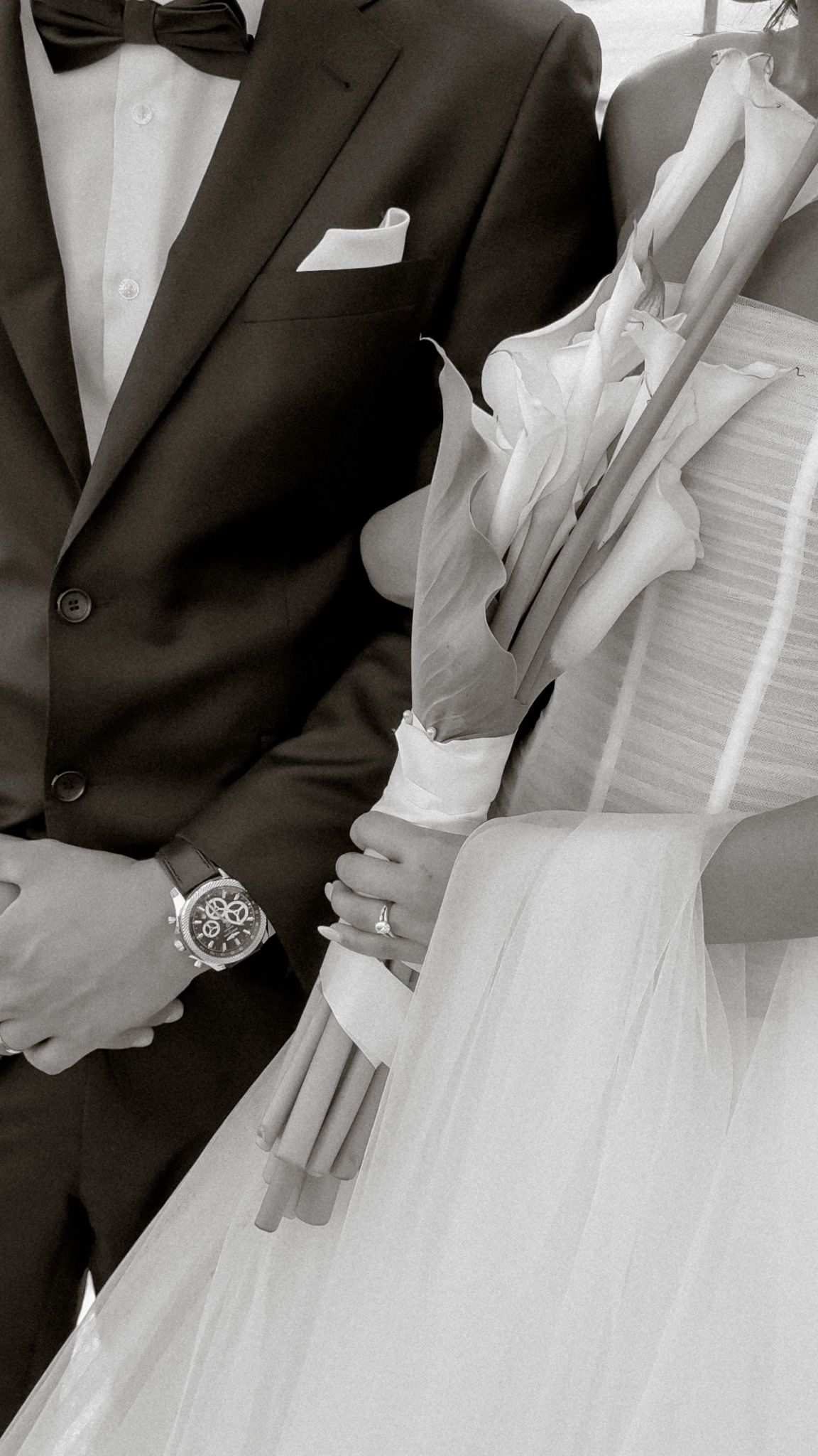 Black and white close-up of bride and groom with elegant bouquet details.