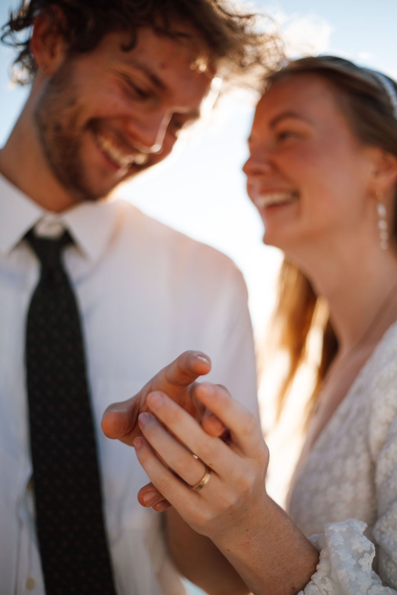 Wedding photography sequence focusing on hands and rings during an intimate moment.