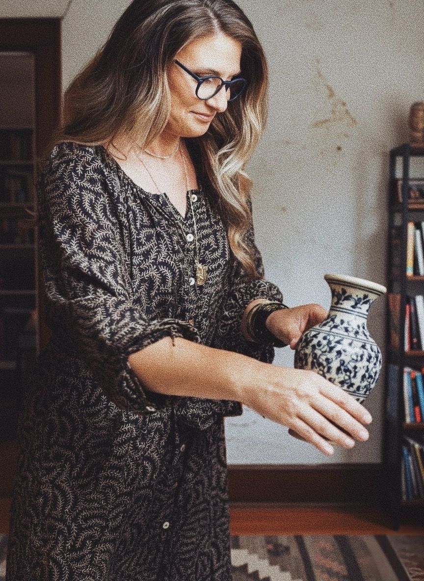 Decorative pottery being handled and displayed in an interior setting.