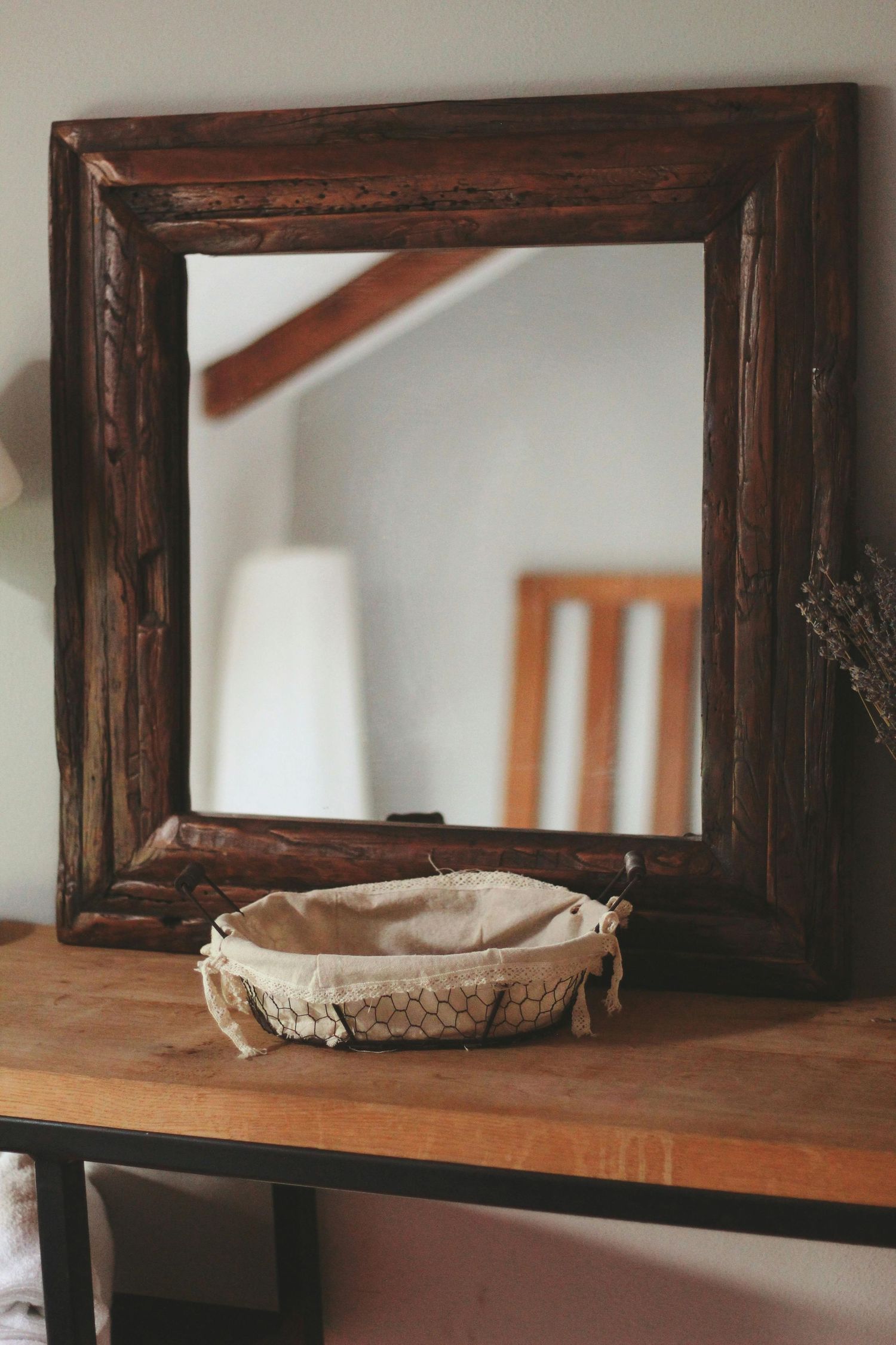 Rustic wooden shelf frames mounted on white wall with decorative elements.