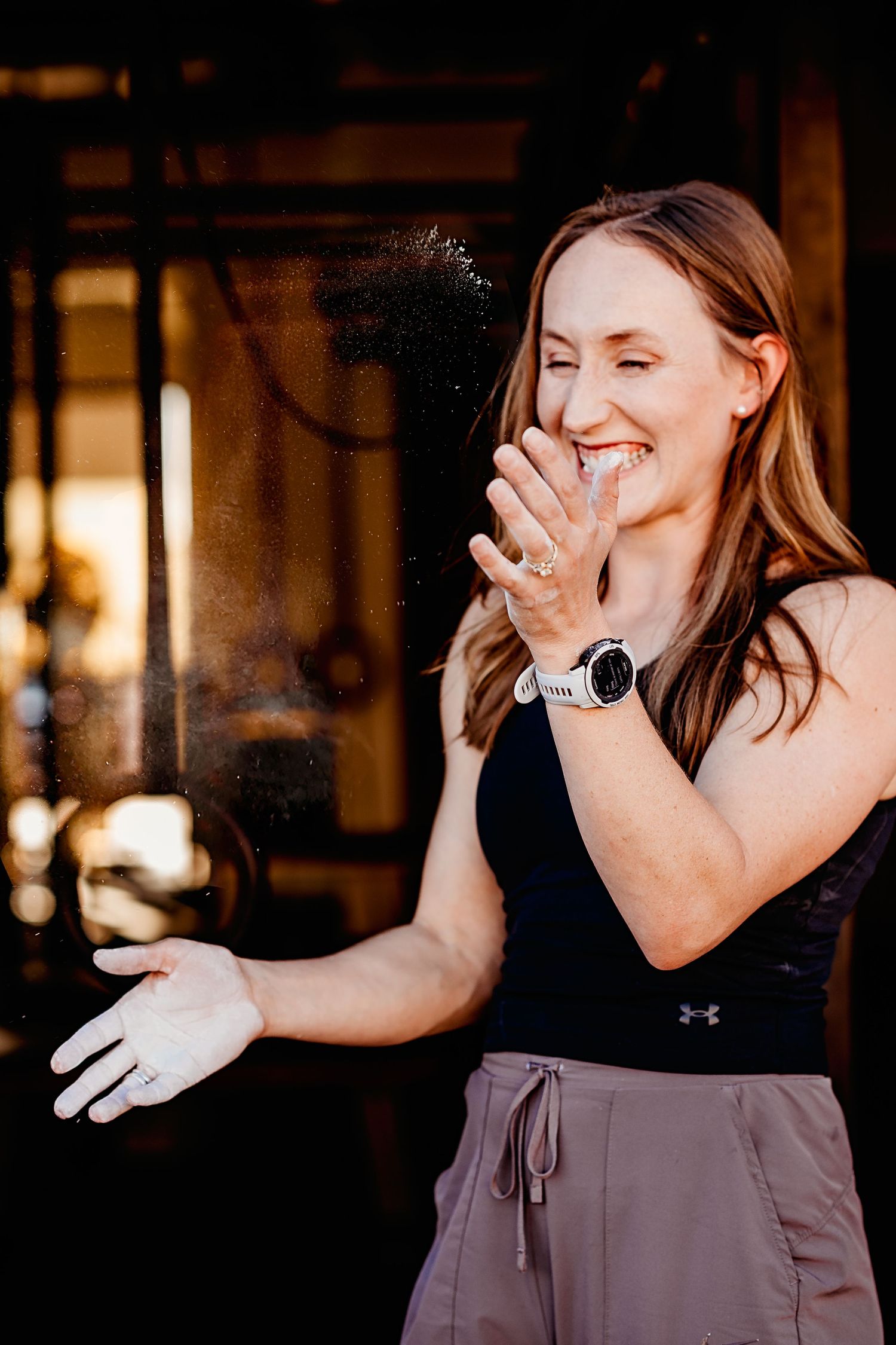 A series of candid photos showing someone laughing and covering their mouth with their hand in a dimly lit setting.