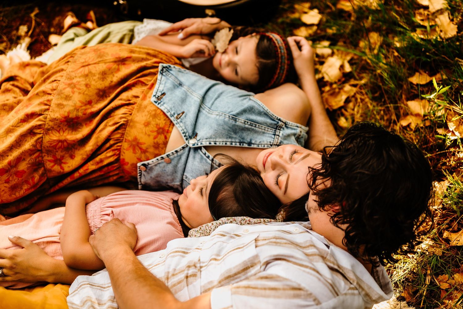 Carefree moments captured lying in nature during sunset with warm golden lighting.