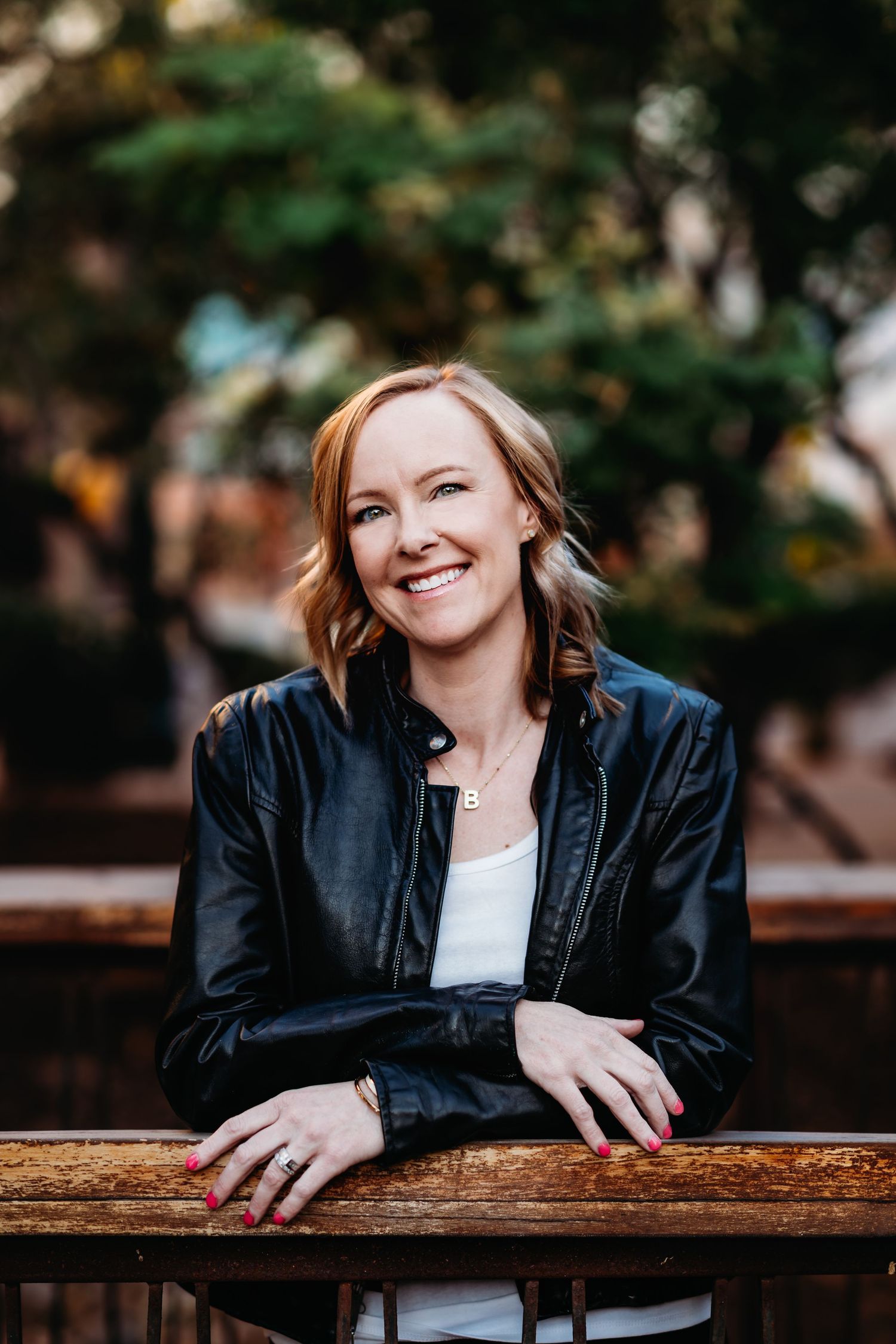 A series of outdoor portraits showing someone in a black leather jacket leaning on a wooden railing with natural lighting.