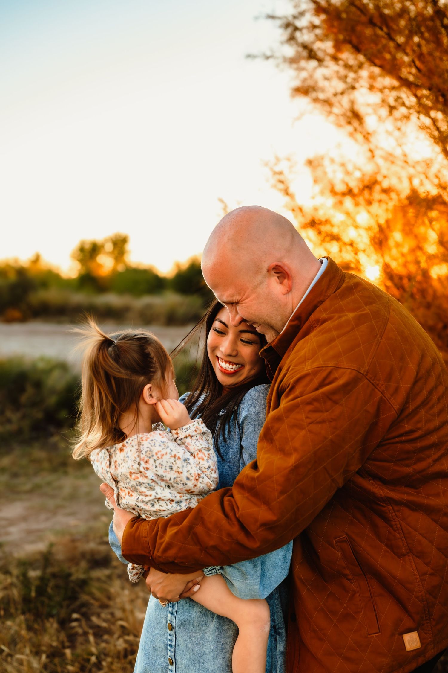 Tender family moments captured during golden hour in a desert setting.