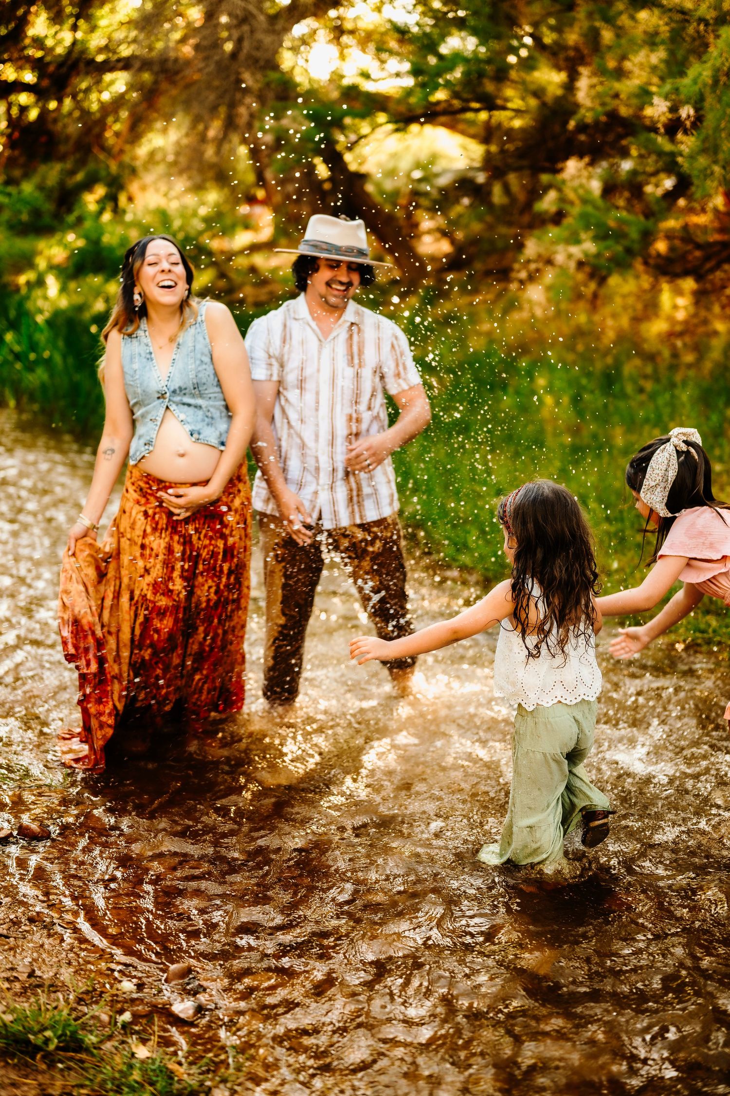 Playful sequence of splashing and laughing in a muddy puddle during golden hour in nature.