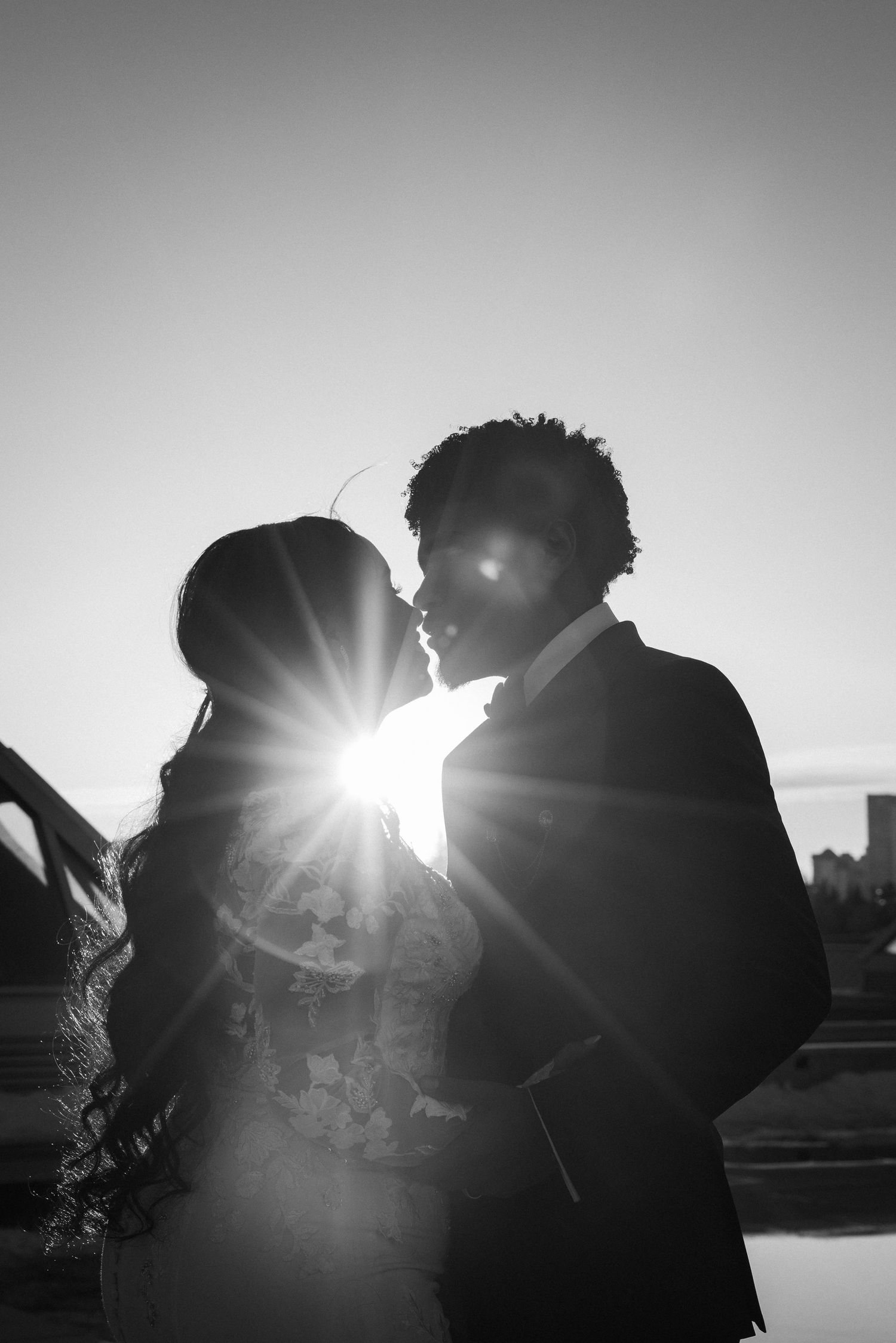 Romantic silhouette against bright sunlight creating dramatic backlit effect.